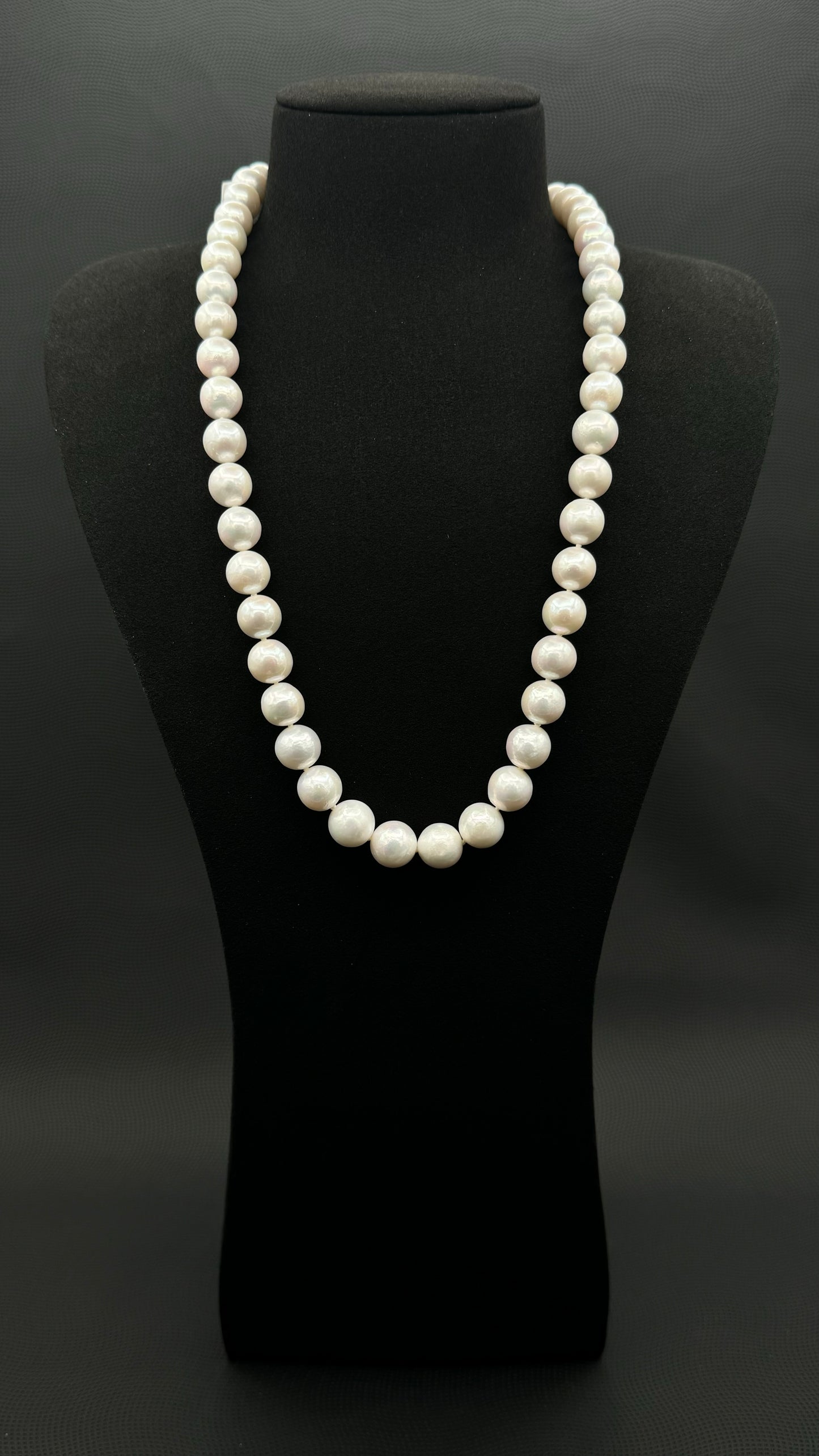 Cultured, South Sea white pearl continuous strand necklace, exhibited on black suede, excellent reflection, 11-12.5mm, 23.5", no clasp.