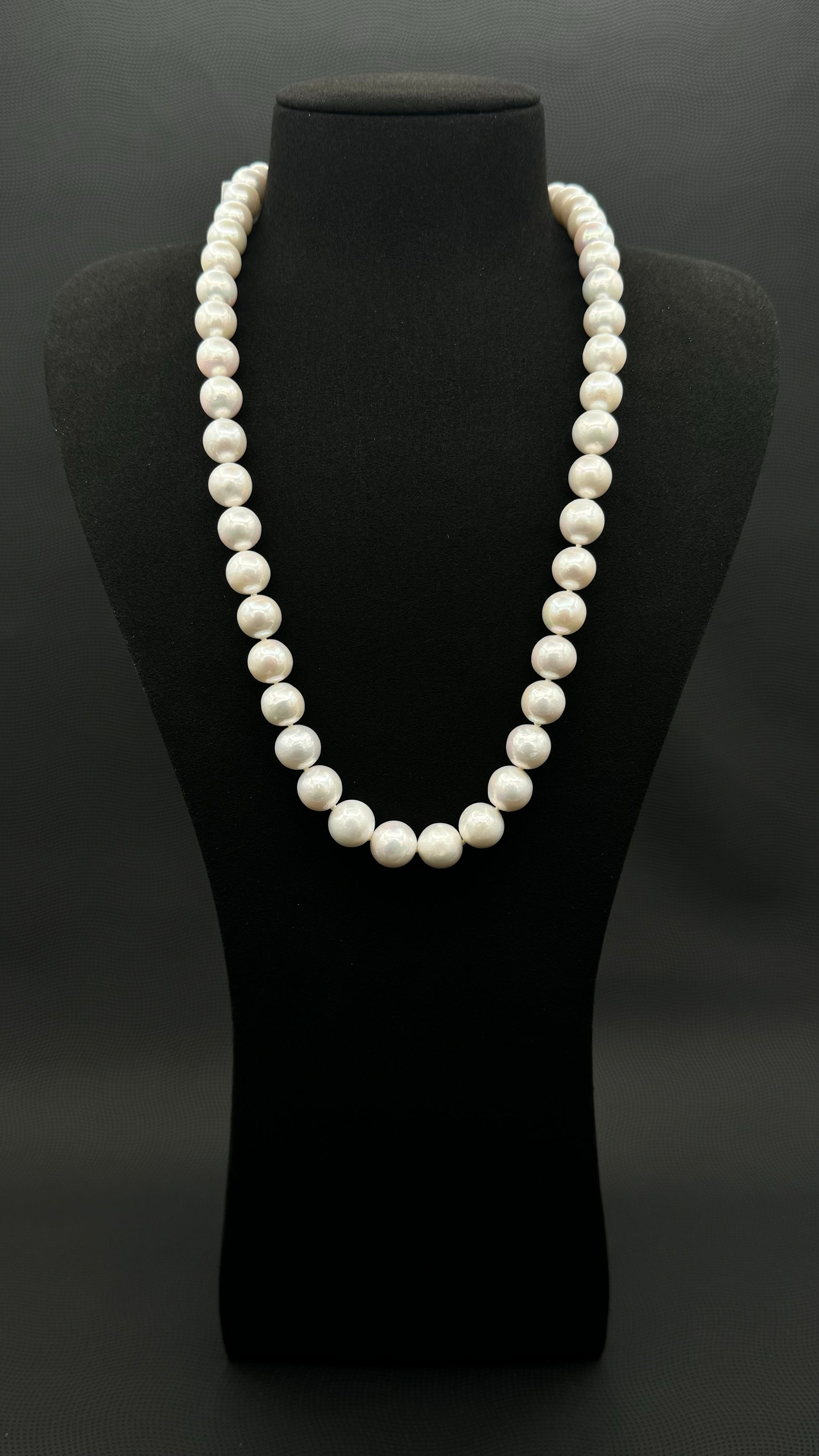 Cultured, South Sea white pearl continuous strand necklace, exhibited on black suede, excellent reflection, 11-12.5mm, 23.5", no clasp.