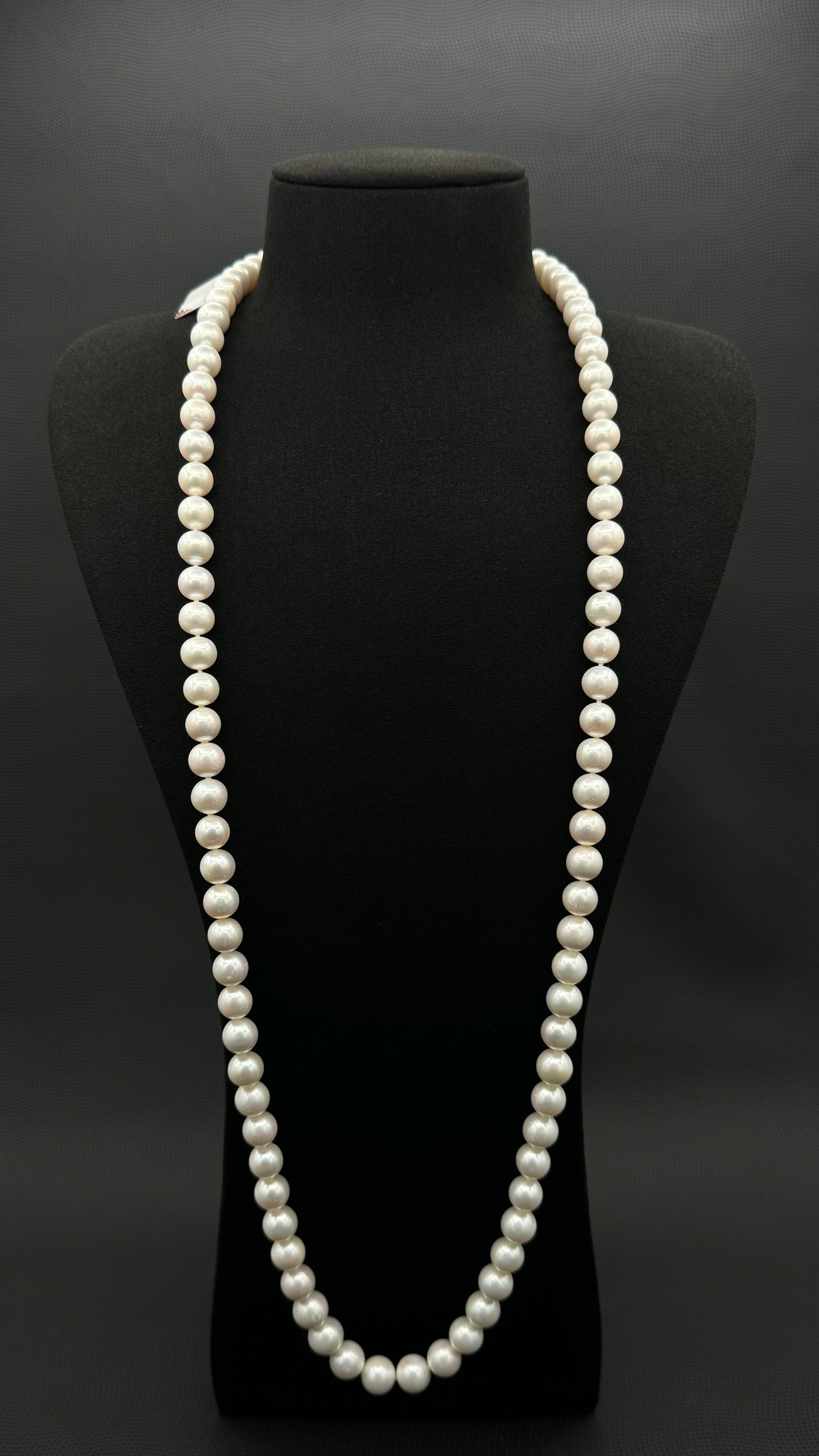 Cultured, South Sea, white continuous strand pearl necklace, exhibited on black suede, excellent reflection, 9-10.5mm, 35.5", 14k white gold clasp.