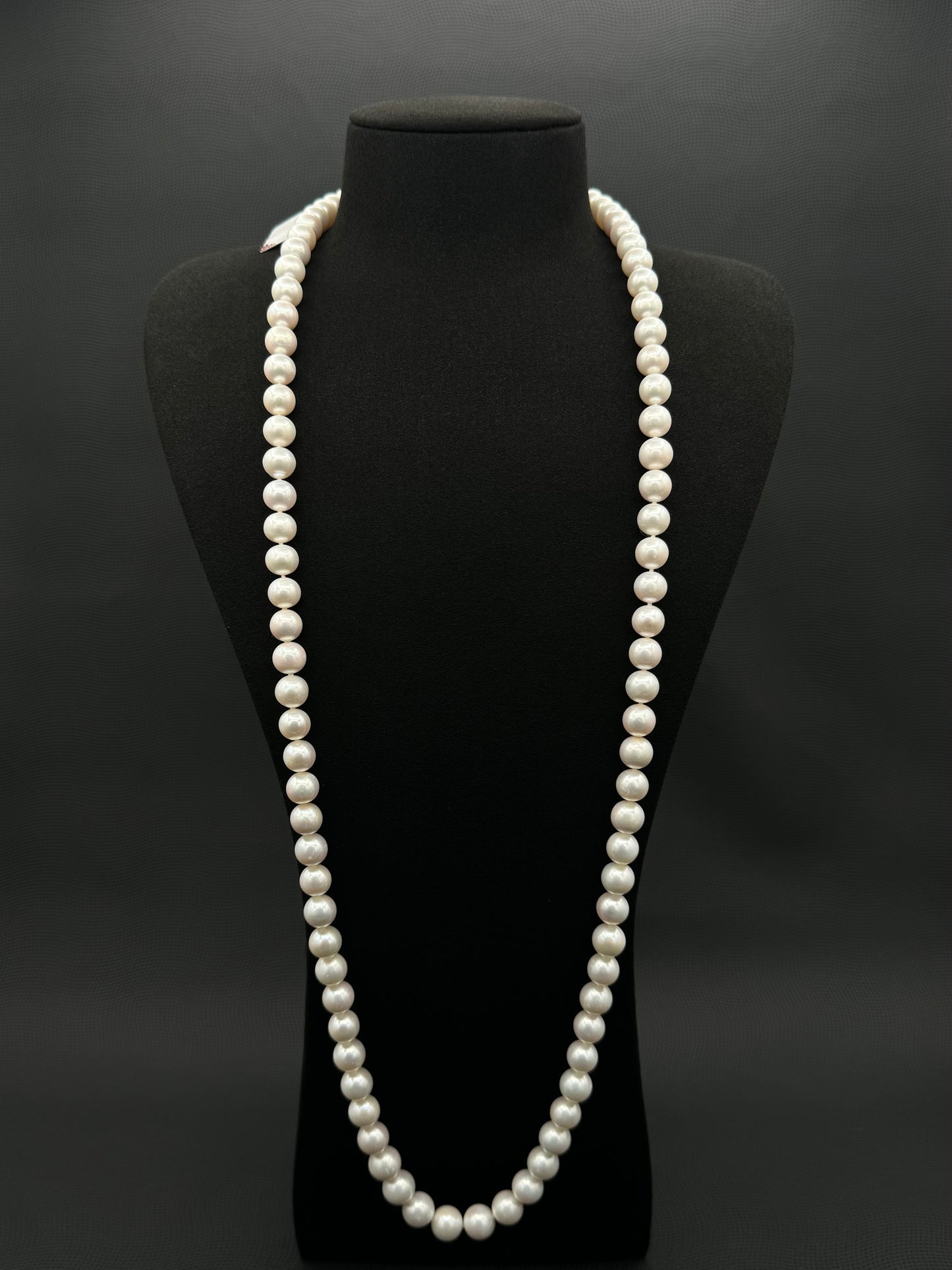 Cultured, South Sea, white continuous strand pearl necklace, exhibited on black suede, excellent reflection, 9-10.5mm, 35.5", 14k white gold clasp.