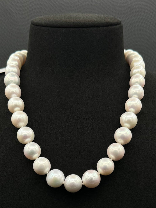 Cultured, South Sea white pearl strand necklace, exhibited on black suede, excellent reflection, 13-14.5mm, 18", white gold clasp.