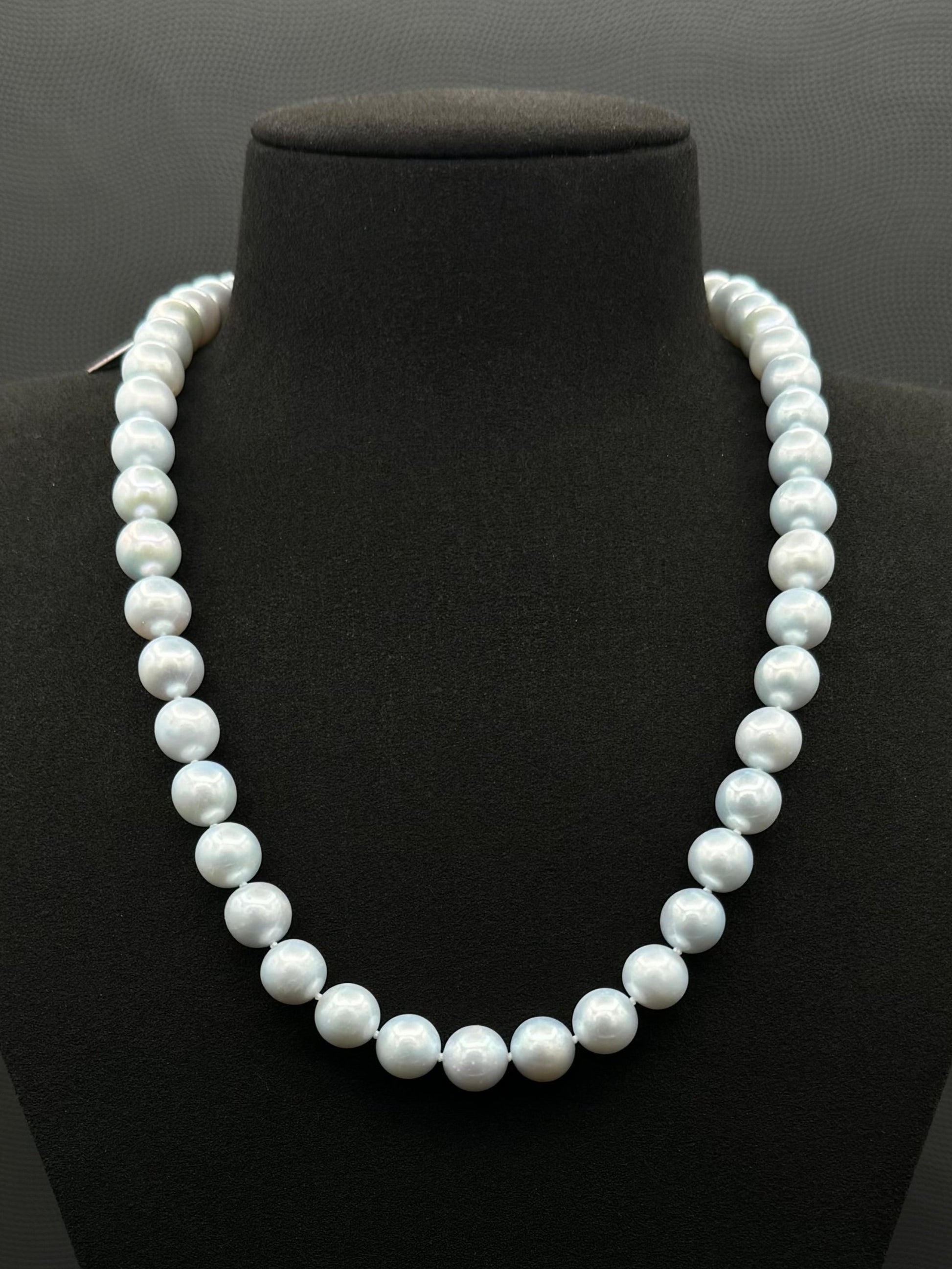Cultured, South Sea blue pearl strand necklace, exhibited on black suede, excellent reflection, 10mm, 20", white gold clasp.