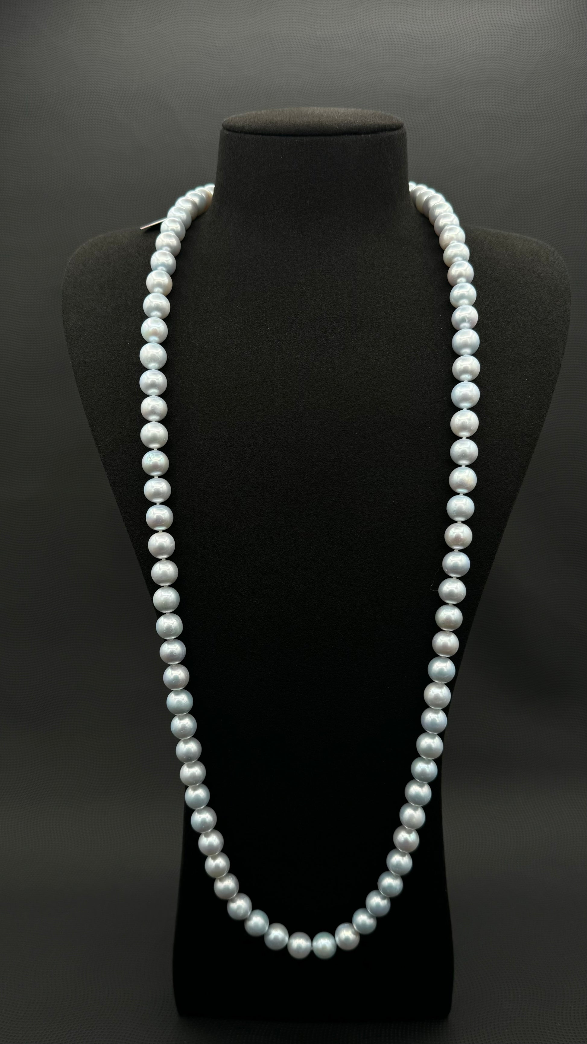 Cultured, South Sea, soft blue continuous strand pearl necklace, exhibited on black suede, excellent reflection, 10-11mm, 35", no clasp.