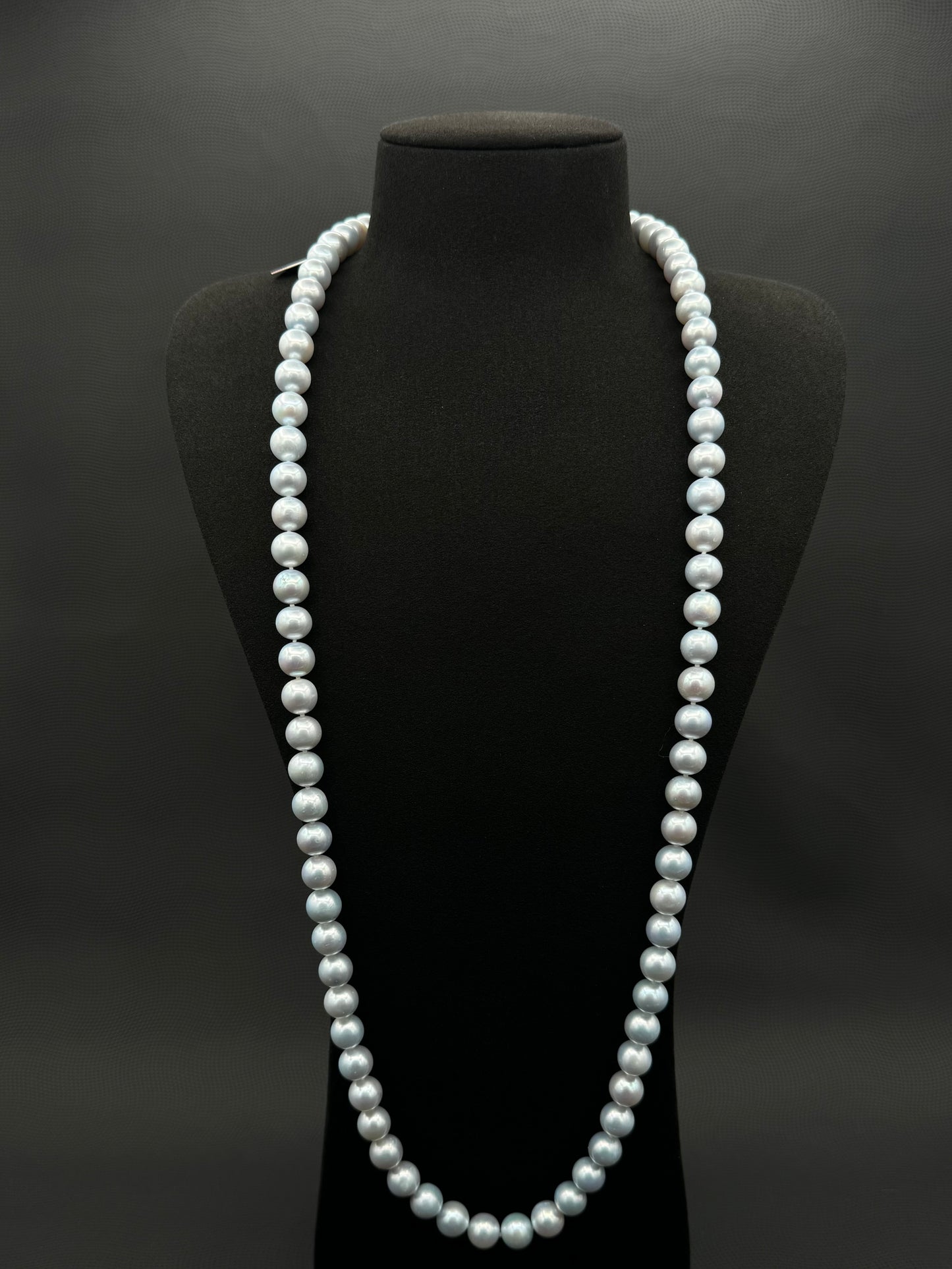 Cultured, South Sea, soft blue continuous strand pearl necklace, exhibited on black suede, excellent reflection, 10-11mm, 35", no clasp.