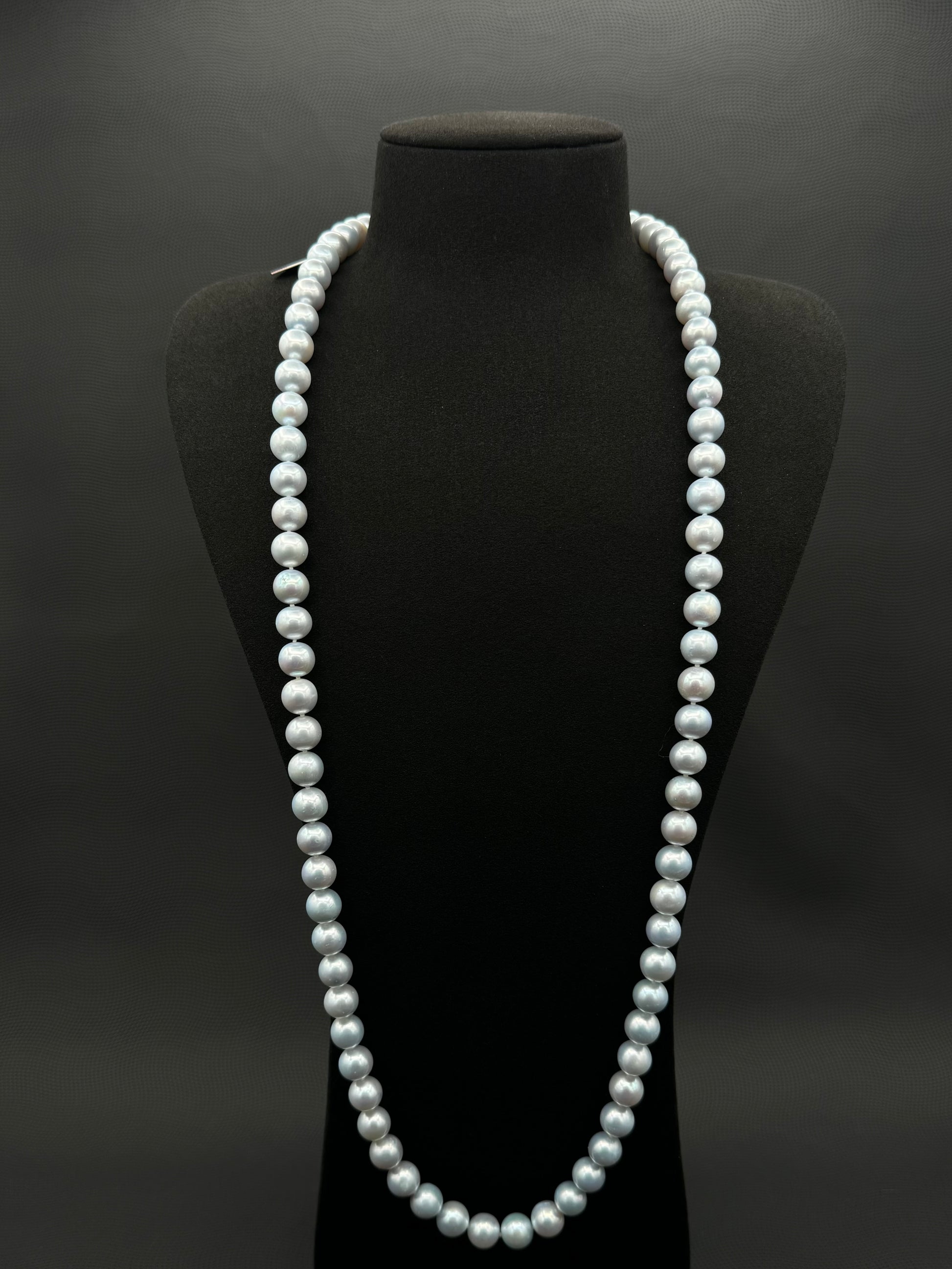 Cultured, South Sea, soft blue continuous strand pearl necklace, exhibited on black suede, excellent reflection, 10-11mm, 35", no clasp.