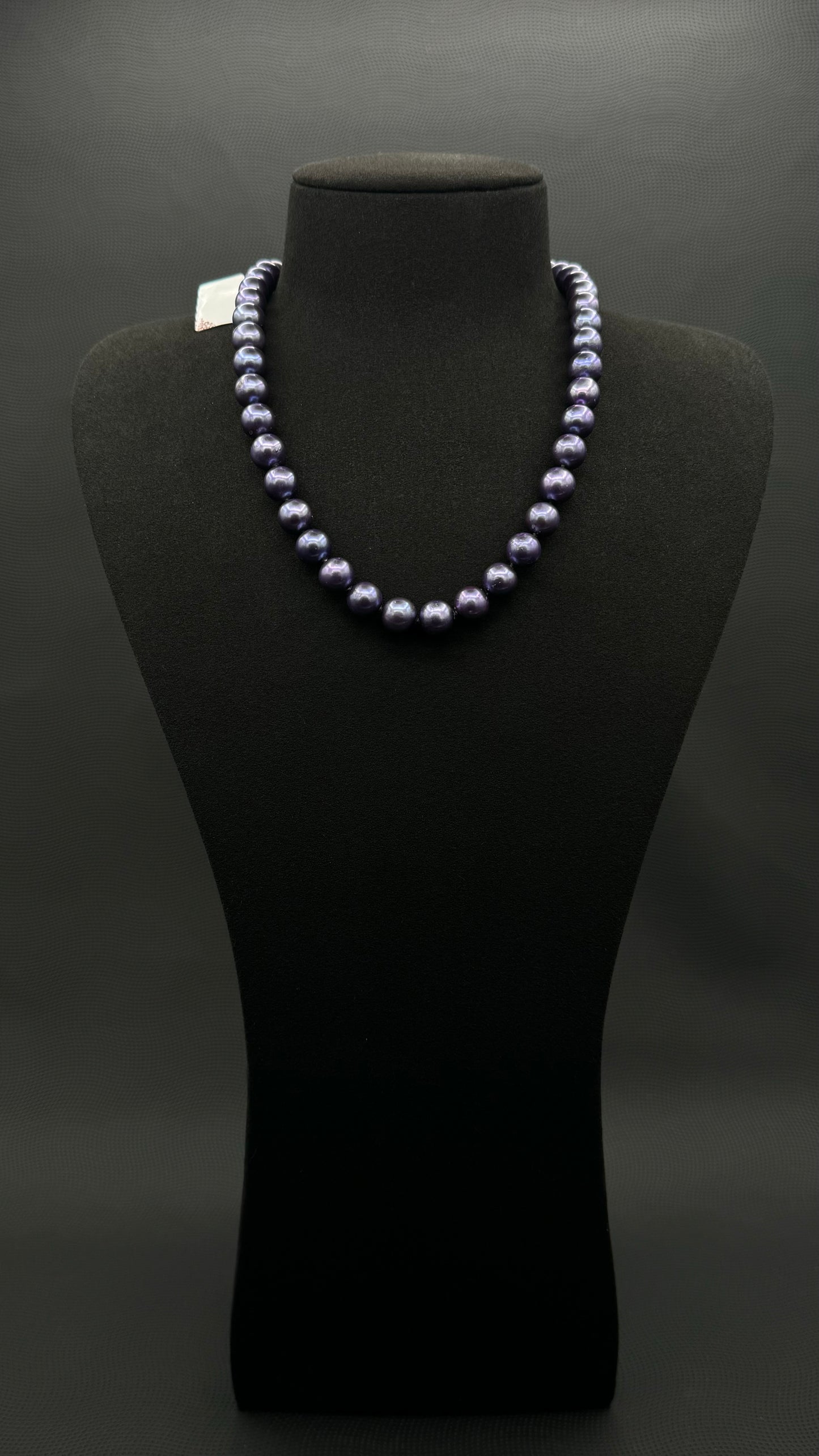 Cultured, Tahitian purple pearl strand necklace, exhibited on black suede, excellent reflection, 9.5-10mm, 17.5", white gold clasp.