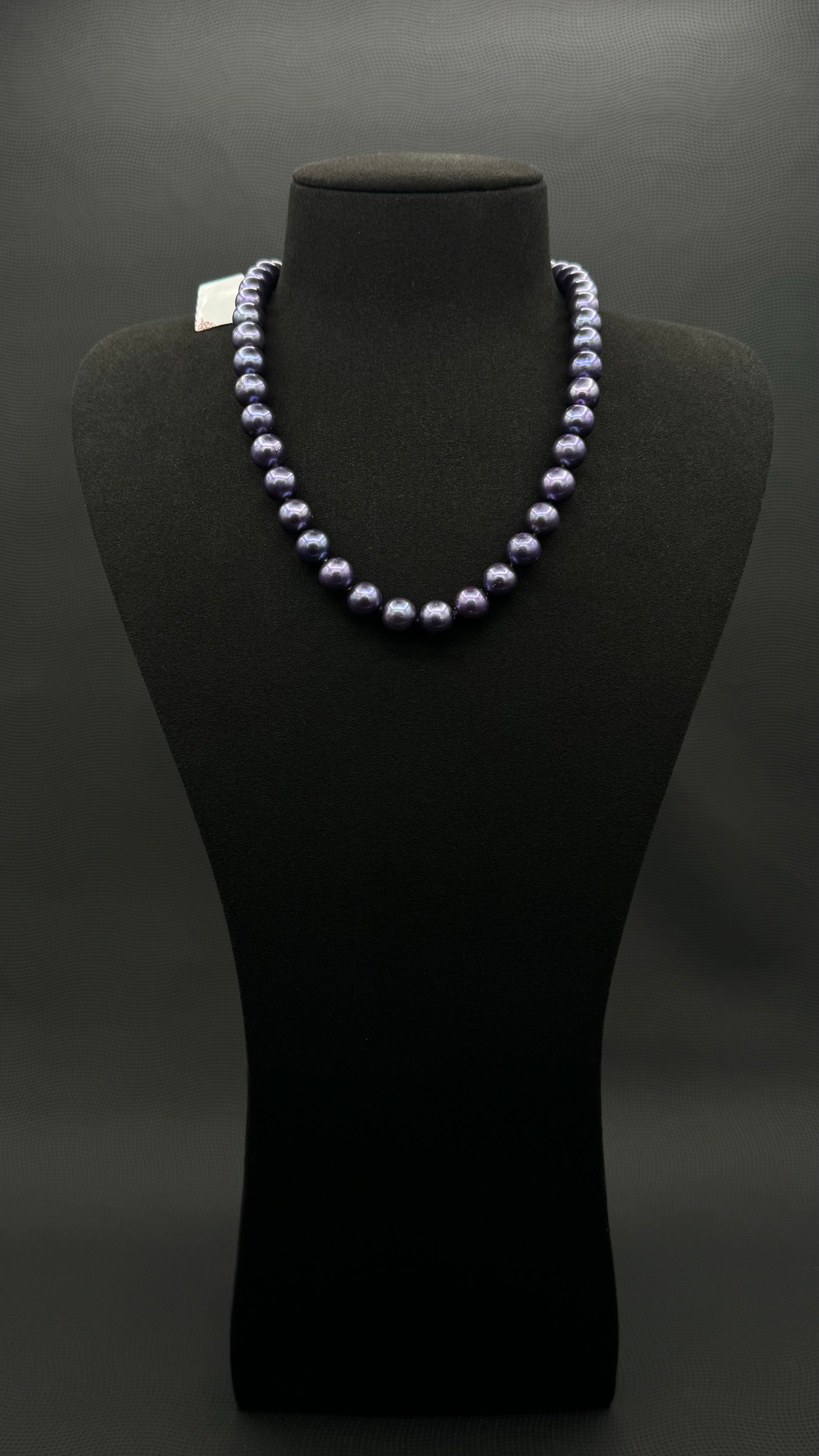 Cultured, Tahitian purple pearl strand necklace, exhibited on black suede, excellent reflection, 9.5-10mm, 17.5", white gold clasp.