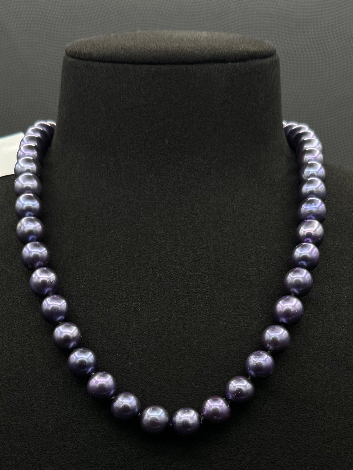 Cultured, Tahitian purple pearl strand necklace, exhibited on black suede, excellent reflection, 9.5-10mm, 17.5", white gold clasp.