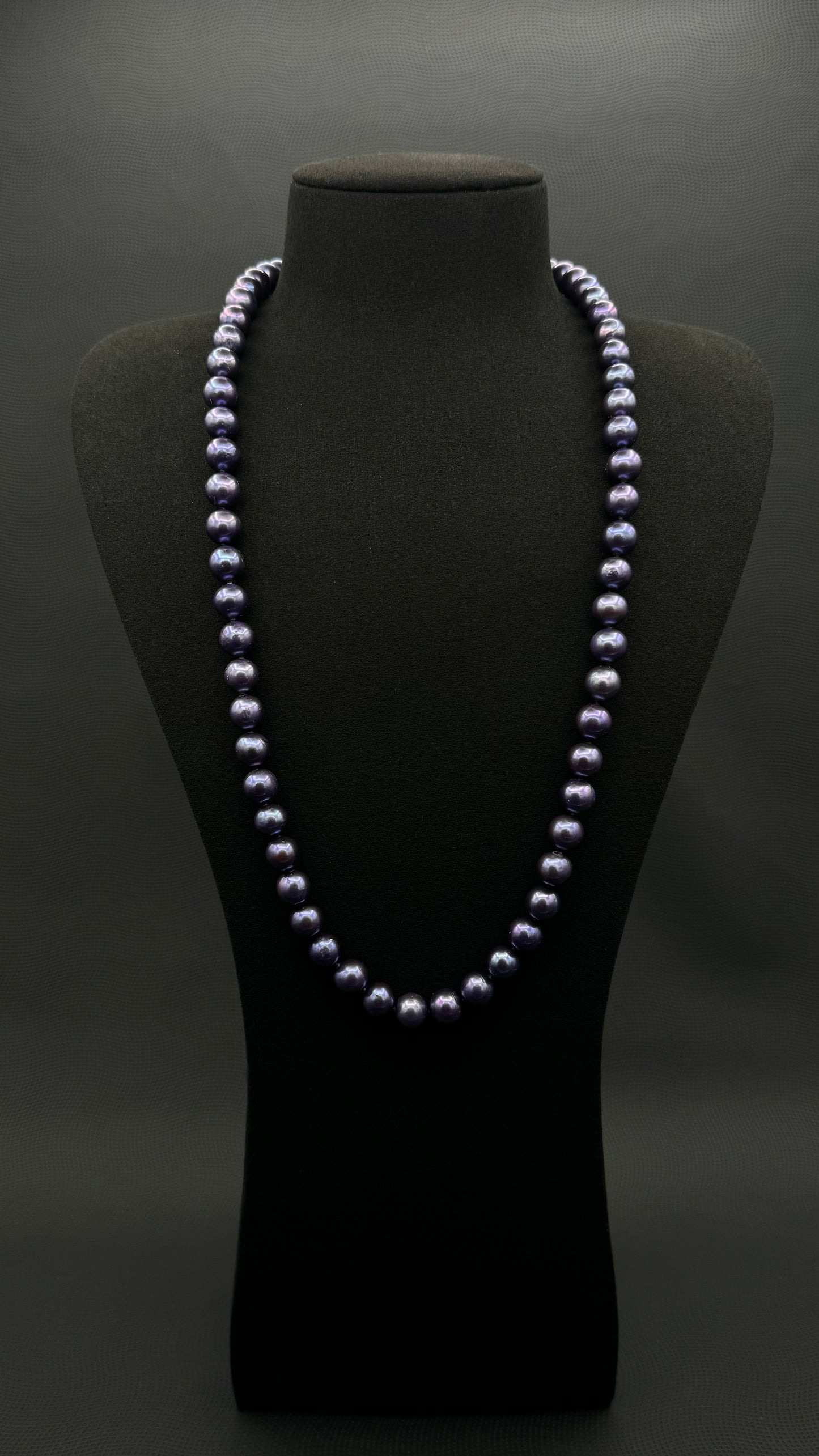Cultured, Tahitian, dark purple continuous strand pearl necklace, exhibited on black suede, excellent reflection, 9.5-10.5mm, 26", no clasp.