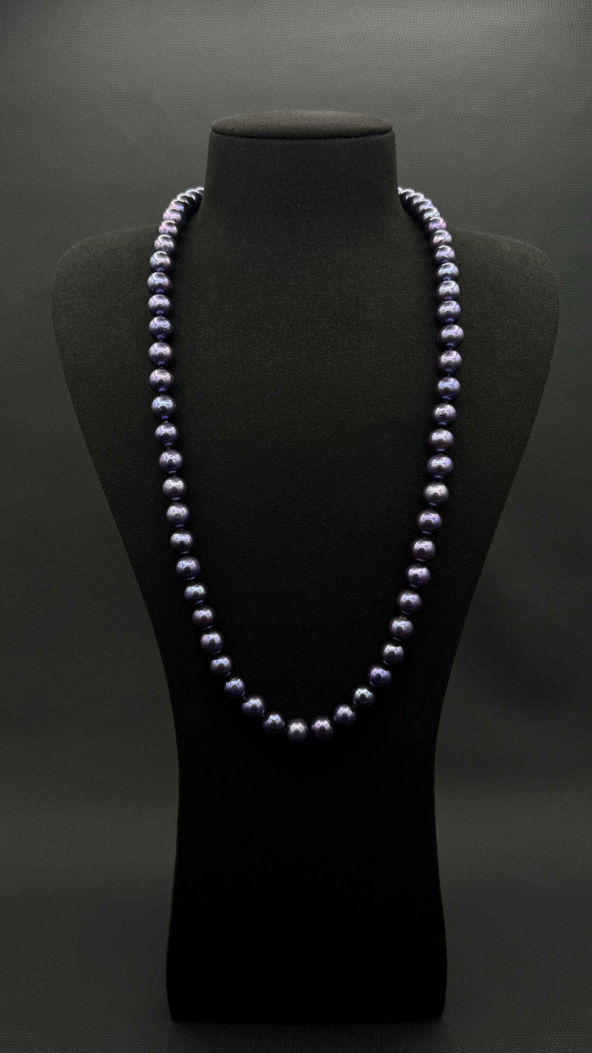 Cultured, Tahitian, dark purple continuous strand pearl necklace, exhibited on black suede, excellent reflection, 9.5-10.5mm, 26", no clasp.