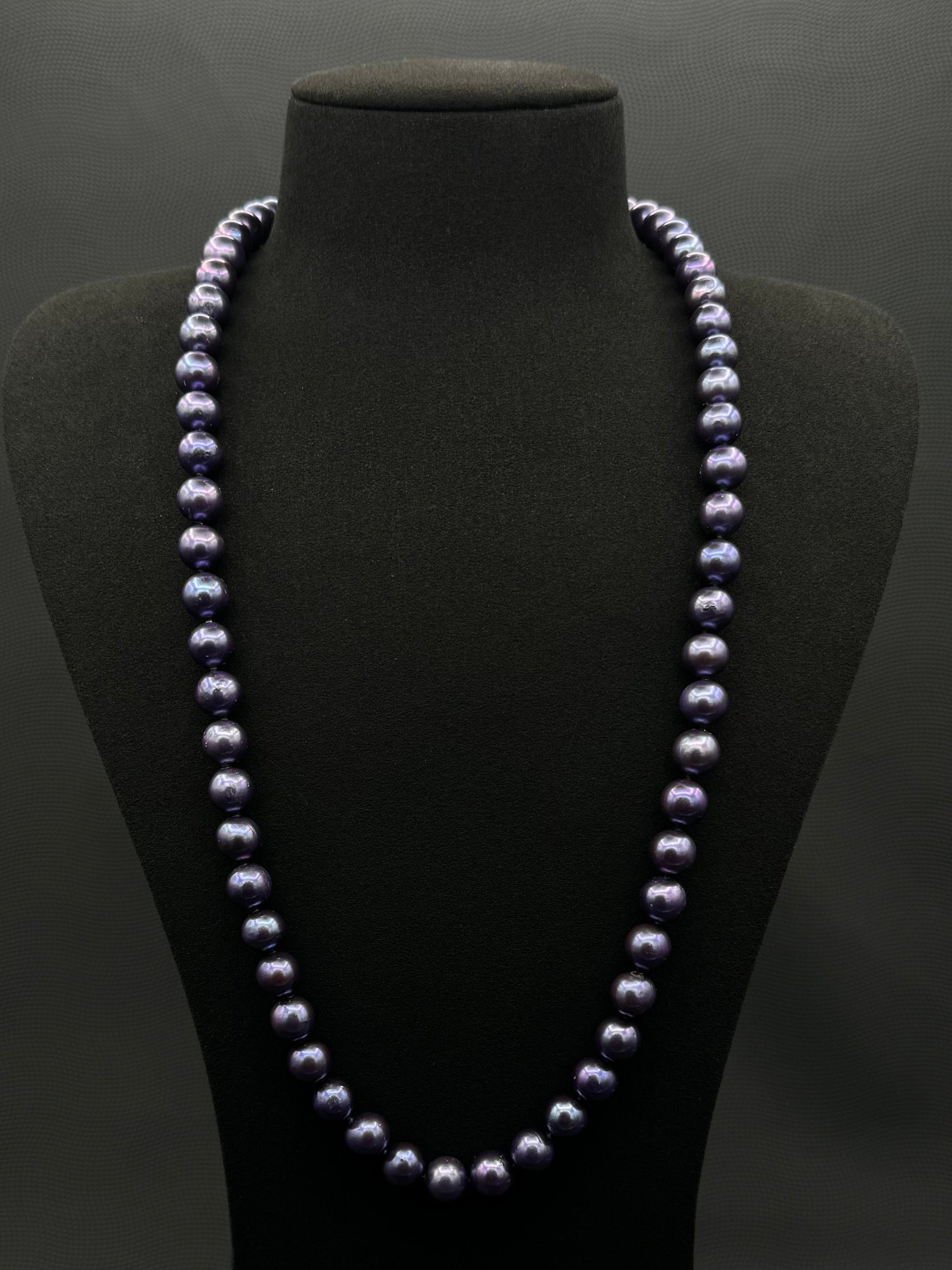 Cultured, Tahitian, dark purple continuous strand pearl necklace, exhibited on black suede, excellent reflection, 9.5-10.5mm, 26", no clasp.