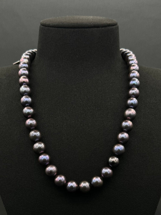 Cultured, Tahitian purple pearl strand necklace, exhibited on black suede, excellent reflection, 10.5-11.5mm, 20", white gold clasp.