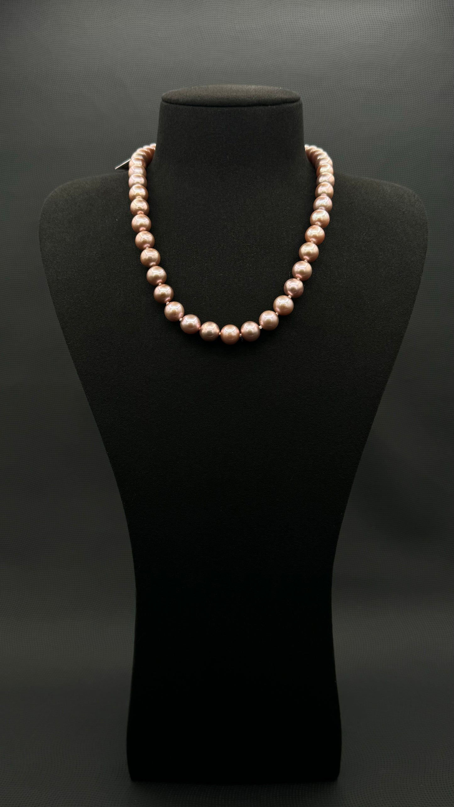 Cultured, South Sea lavender pearl strand necklace, exhibited on black suede, excellent reflection, 9.5-12.5mm, 19", yellow gold clasp.