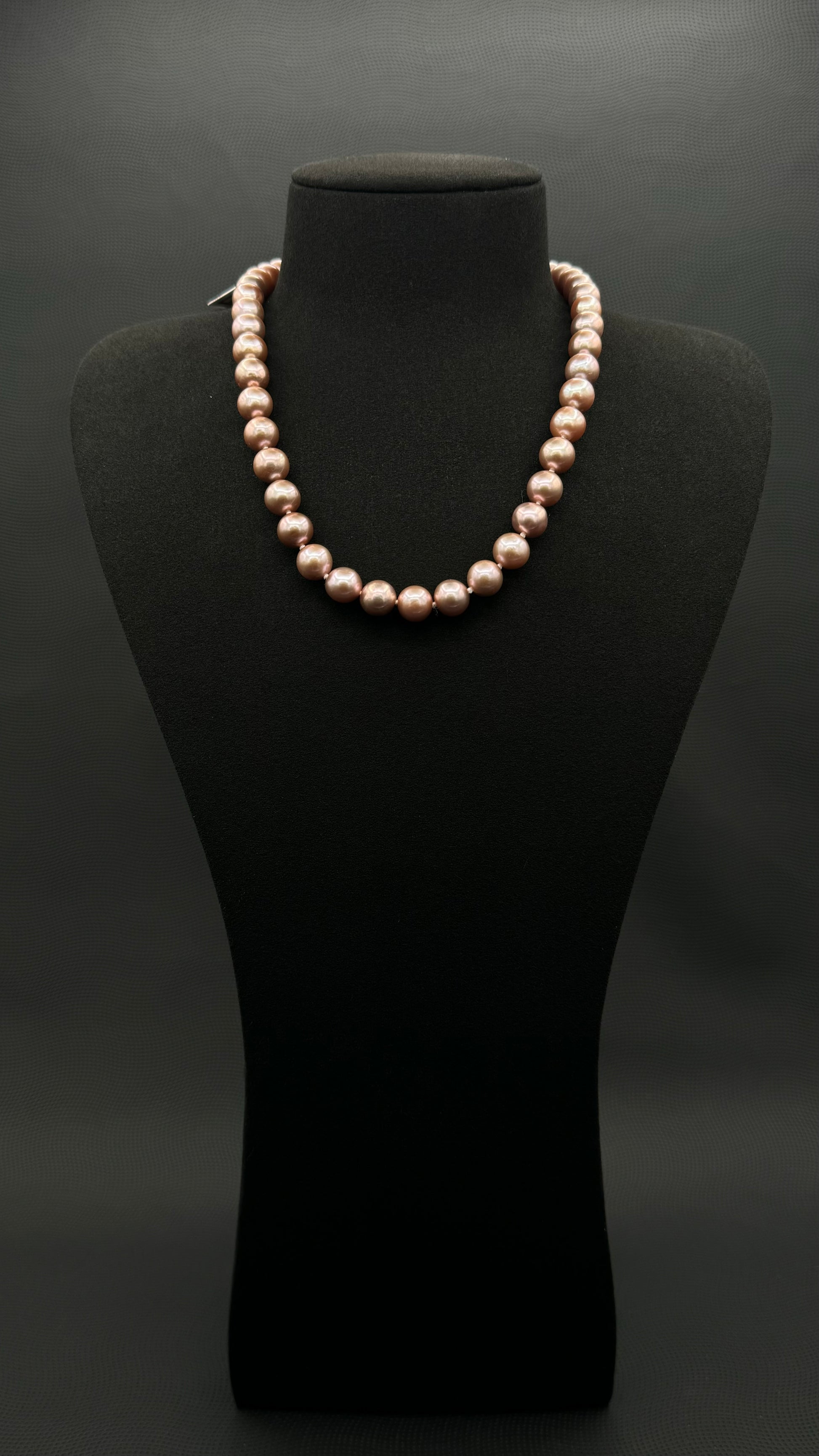 Cultured, South Sea lavender pearl strand necklace, exhibited on black suede, excellent reflection, 9.5-12.5mm, 19", yellow gold clasp.
