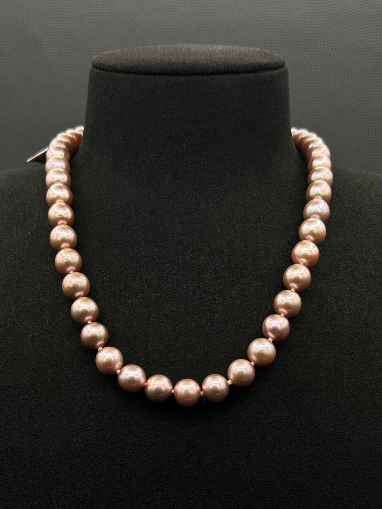 Cultured, South Sea lavender pearl strand necklace, exhibited on black suede, excellent reflection, 9.5-12.5mm, 19", yellow gold clasp.