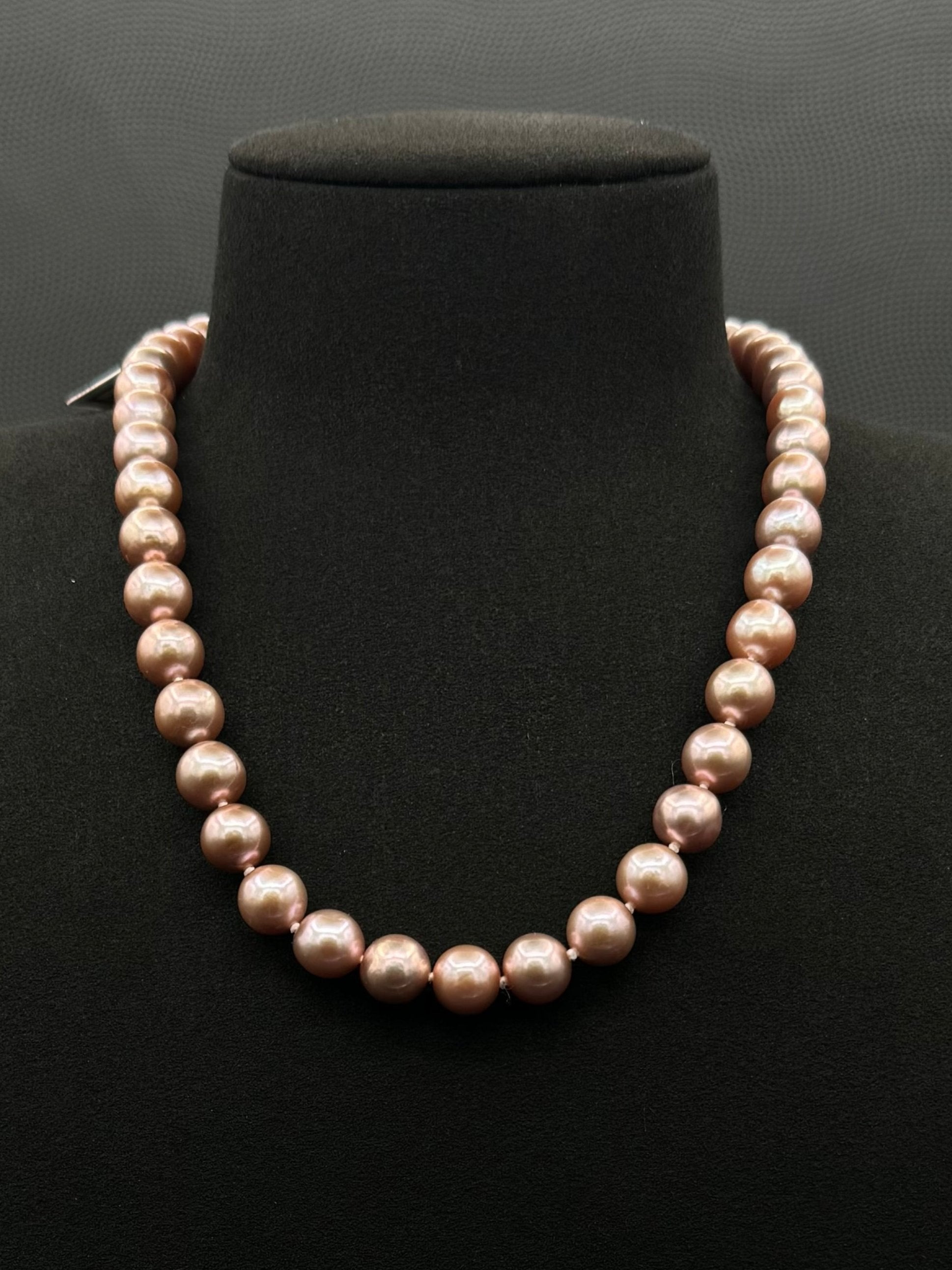 Cultured, South Sea lavender pearl strand necklace, exhibited on black suede, excellent reflection, 9.5-12.5mm, 19", yellow gold clasp.
