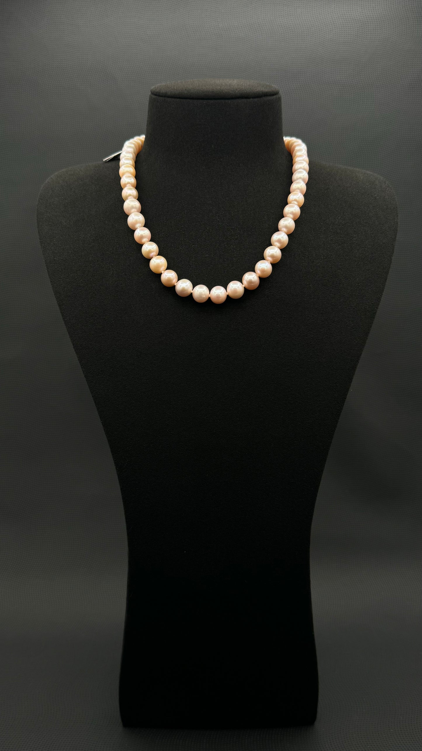 Cultured, South Sea soft-pink pearl strand necklace, exhibited on black suede, excellent reflection, 8.5-9.5mm, 17", yellow plated clasp.