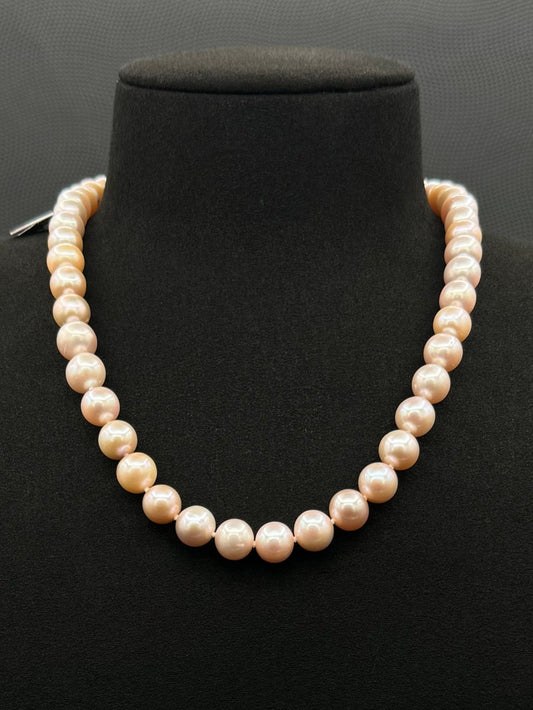 Cultured, South Sea soft-pink pearl strand necklace, exhibited on black suede, excellent reflection, 8.5-9.5mm, 17", yellow plated clasp.