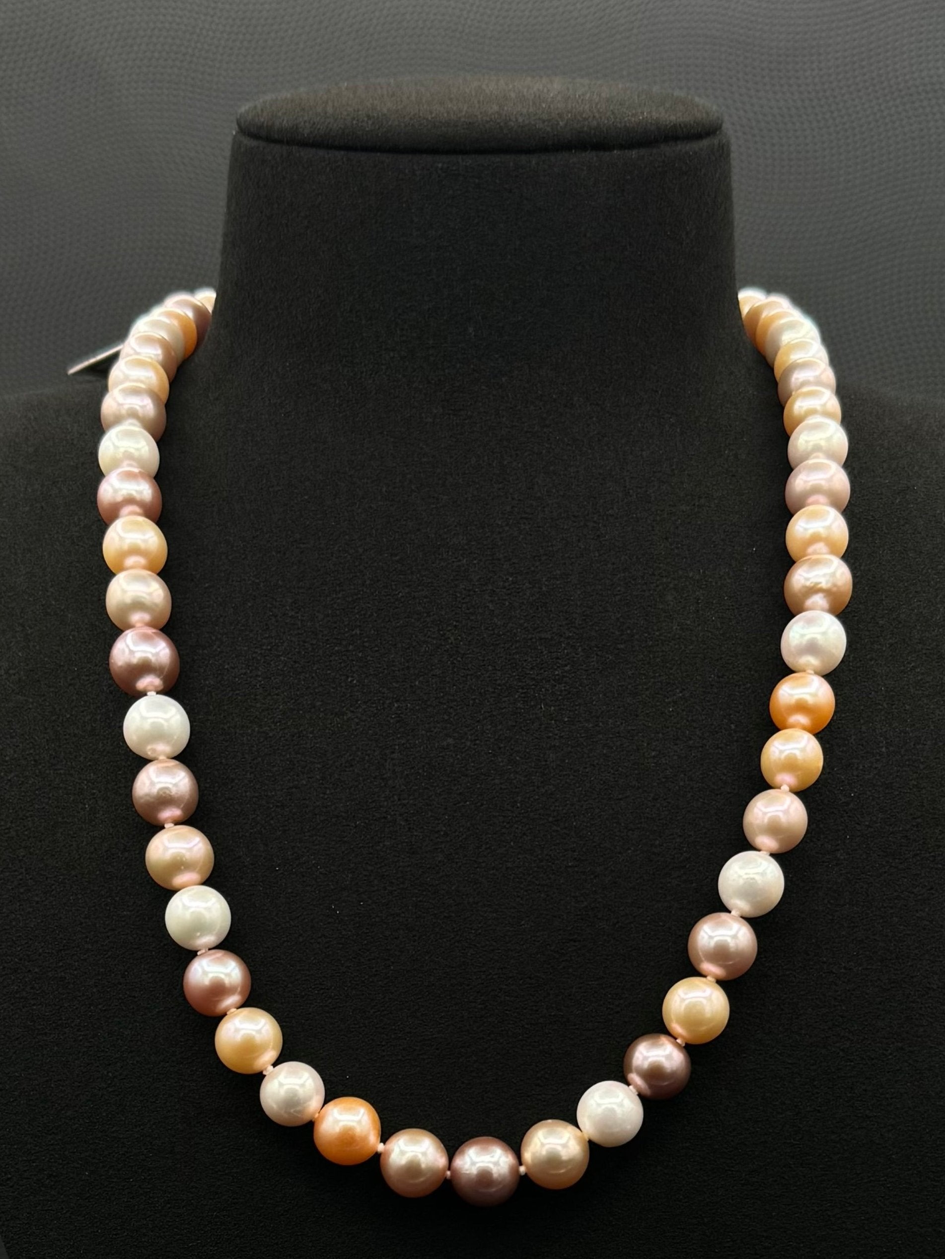 Cultured, South Sea mixed pink pearl strand necklace, exhibited on black suede, excellent reflection, 8-10mm, 20", yellow gold clasp.