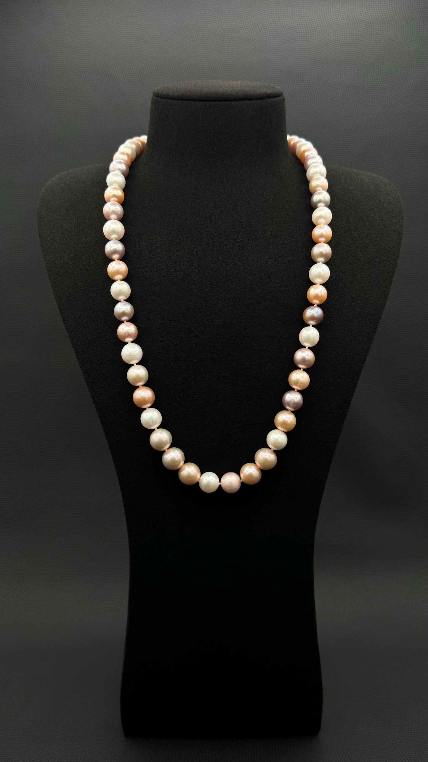 Cultured, South Sea mixed pinks pearl continuous strand necklace, exhibited on black suede, excellent reflection, 10.5-12mm, 23.5", no clasp.