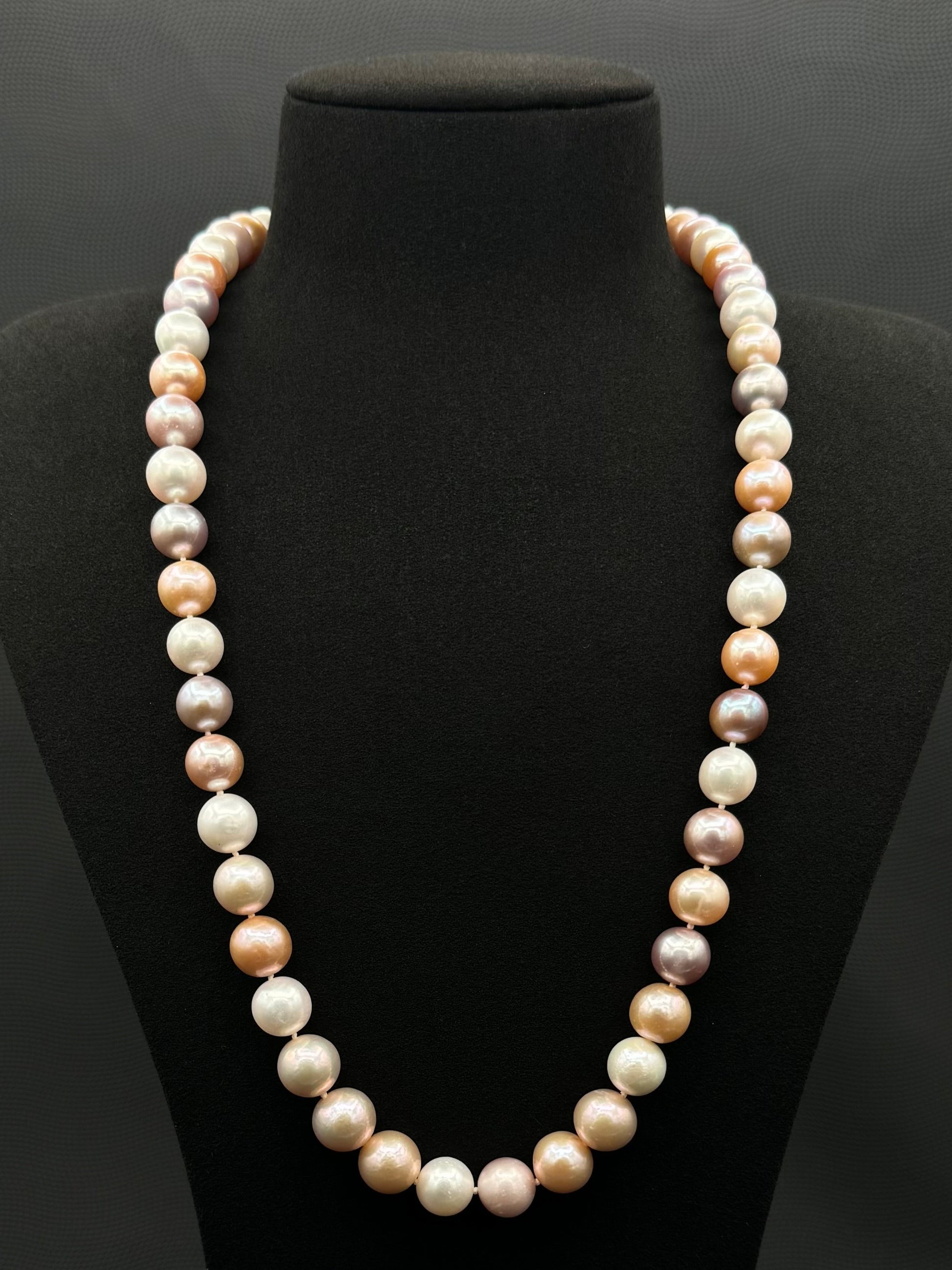Cultured, South Sea mixed pinks pearl continuous strand necklace, exhibited on black suede, excellent reflection, 10.5-12mm, 23.5", no clasp.
