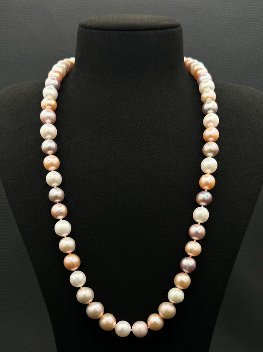 Cultured, South Sea mixed pinks pearl continuous strand necklace, exhibited on black suede, excellent reflection, 10.5-12mm, 23.5", no clasp.