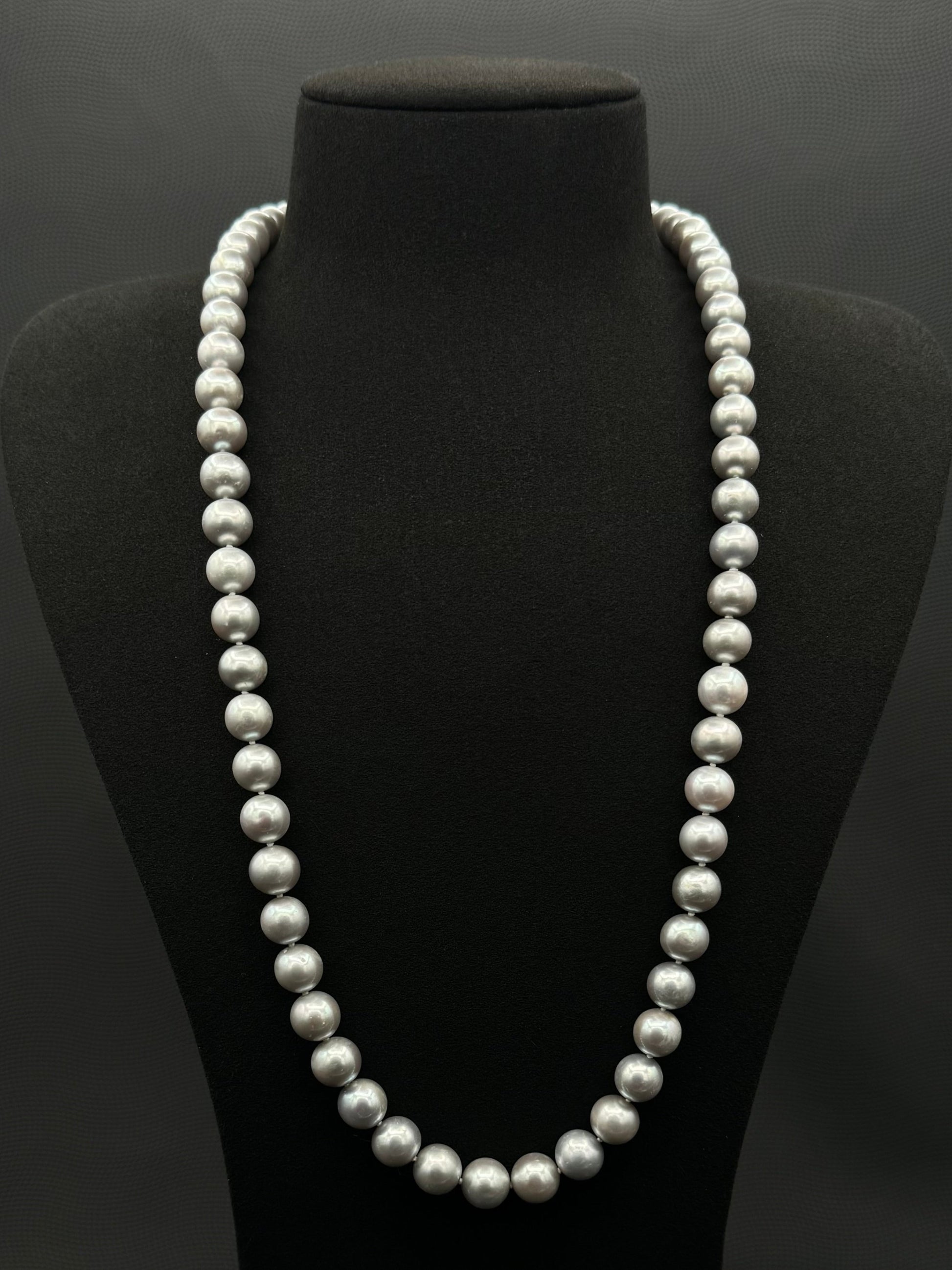 Cultured, South Sea, soft grey continuous strand pearl necklace, exhibited on black suede, excellent reflection, 9.5-10.5mm, 26", no clasp.