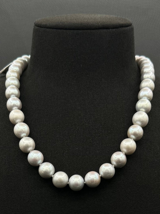 Cultured, South Sea soft grey pearl strand necklace, exhibited on black suede, sound reflection, 10.5-11mm, 18", white gold clasp.