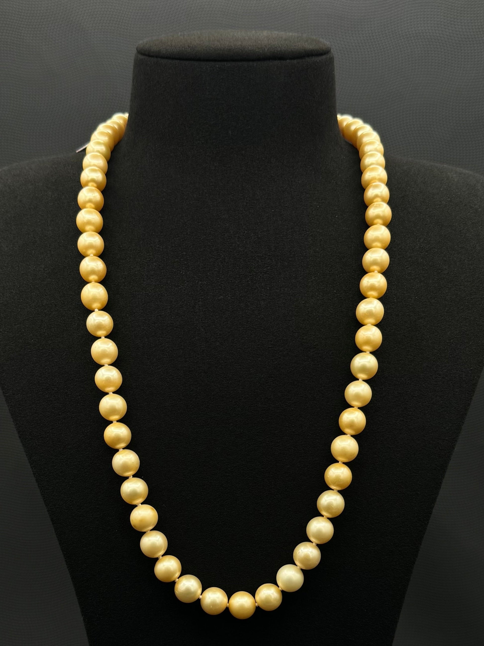 Cultured, South Sea, golden pearl continuous strand necklace, exhibited on black suede, fair reflection, 8.5-10mm, 23.5", no clasp.