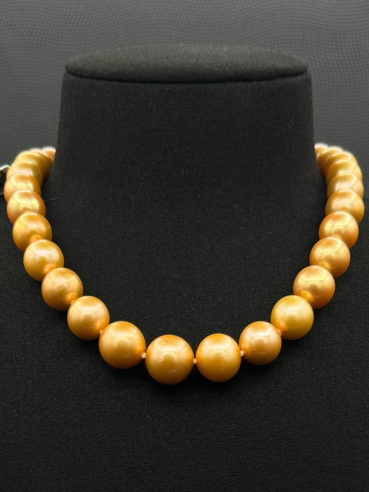 Cultured, South Sea, deep gold pearl necklace, exhibited on black suede, excellent reflection, 11-13.5mm, 15.5", 14k yellow gold clasp.