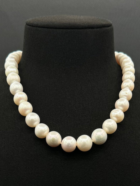 Cultured, South Sea white pearl strand necklace, exhibited on black suede, fair reflection, 9.5-12.5mm, 16", sterling silver clasp.