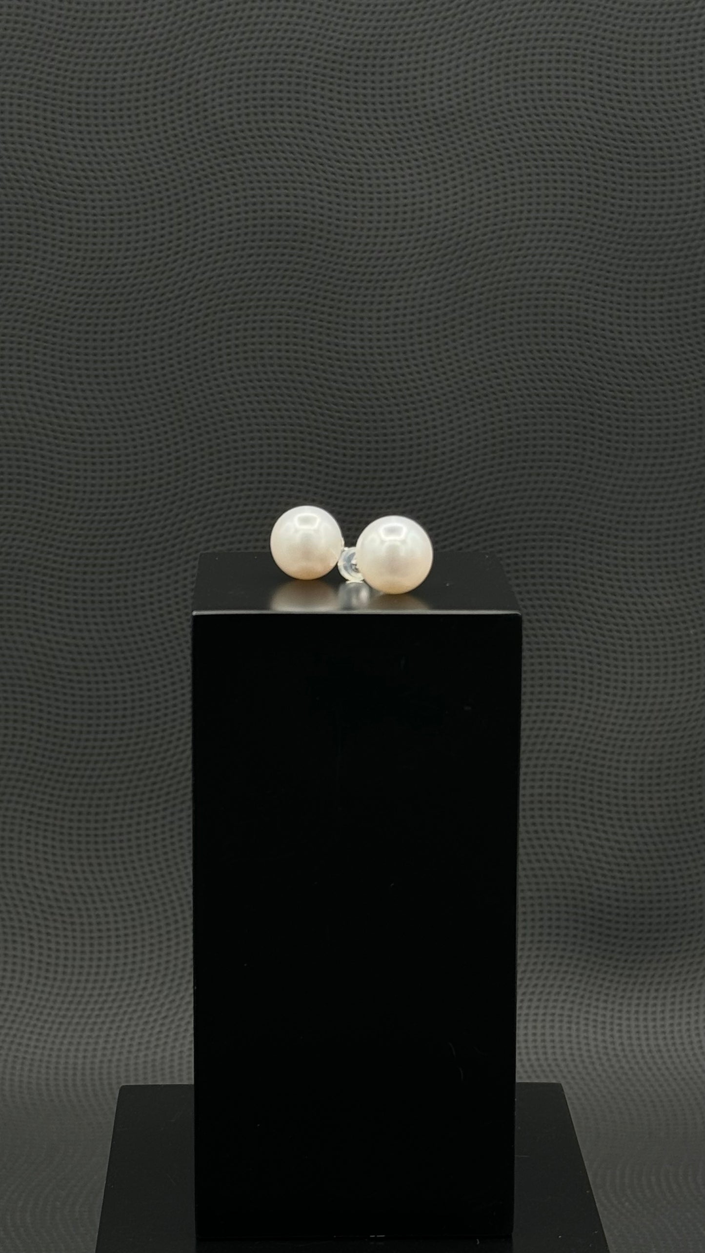 Cultured, South Sea, pearl earrings, exhibited on black box, white, stud style, extremely sharp, 12mm, 18k white gold.