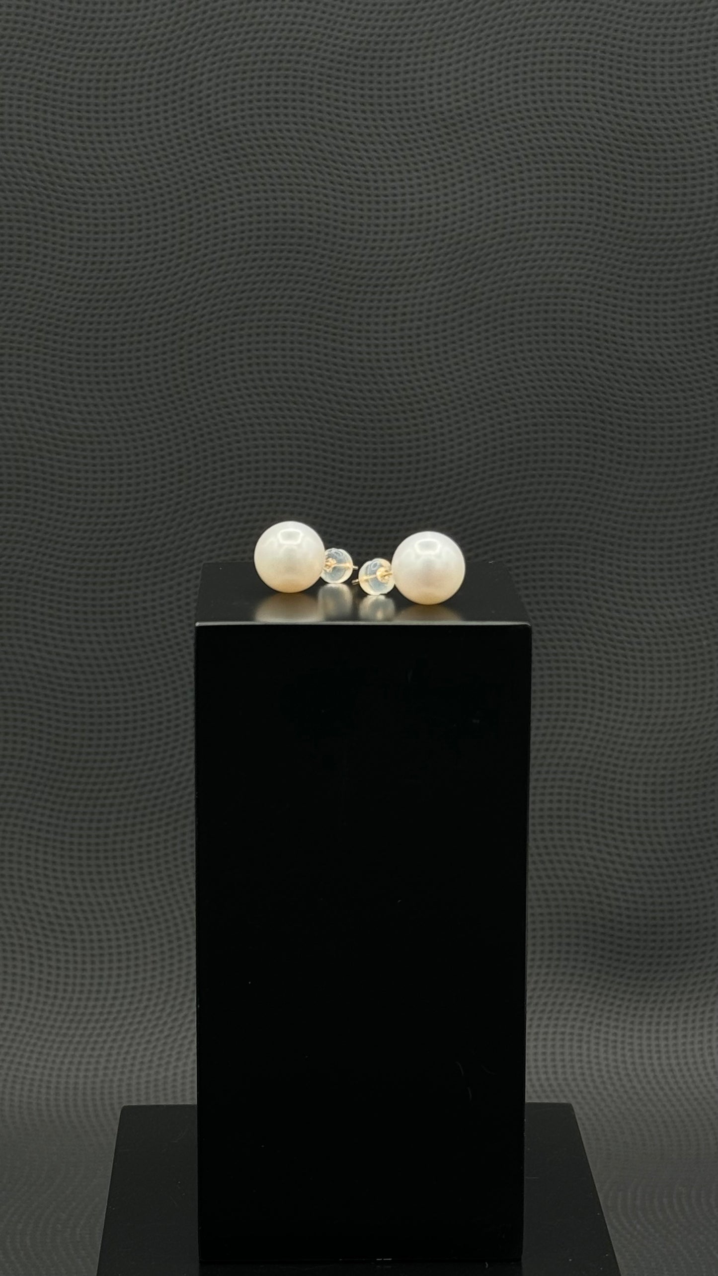 Cultured, South Sea, pearl earrings, exhibited on black box, white, stud style, sound reflection, 11mm, 18k white gold.