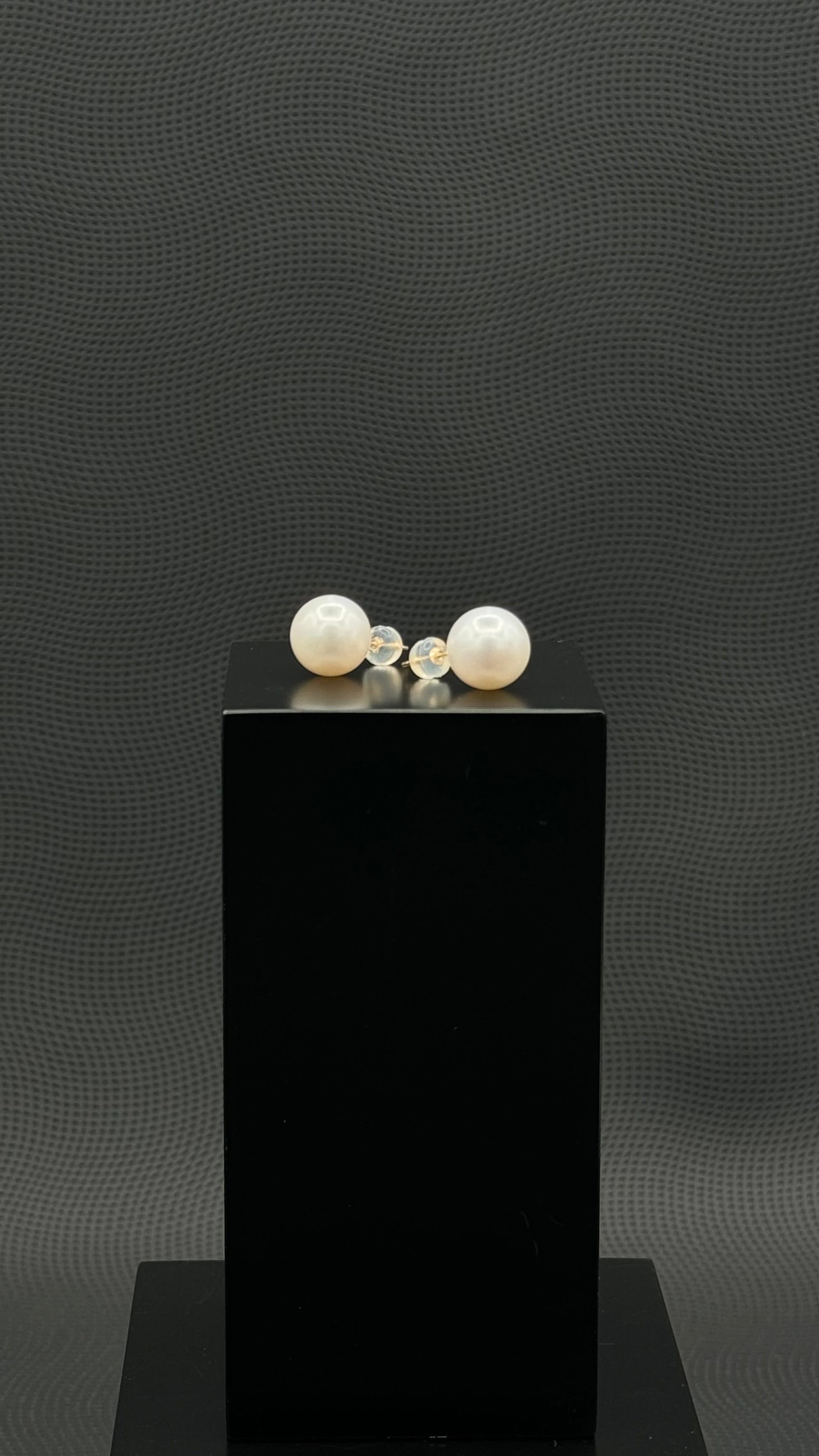 Cultured, South Sea, pearl earrings, exhibited on black box, white, stud style, sound reflection, 11mm, 18k white gold.