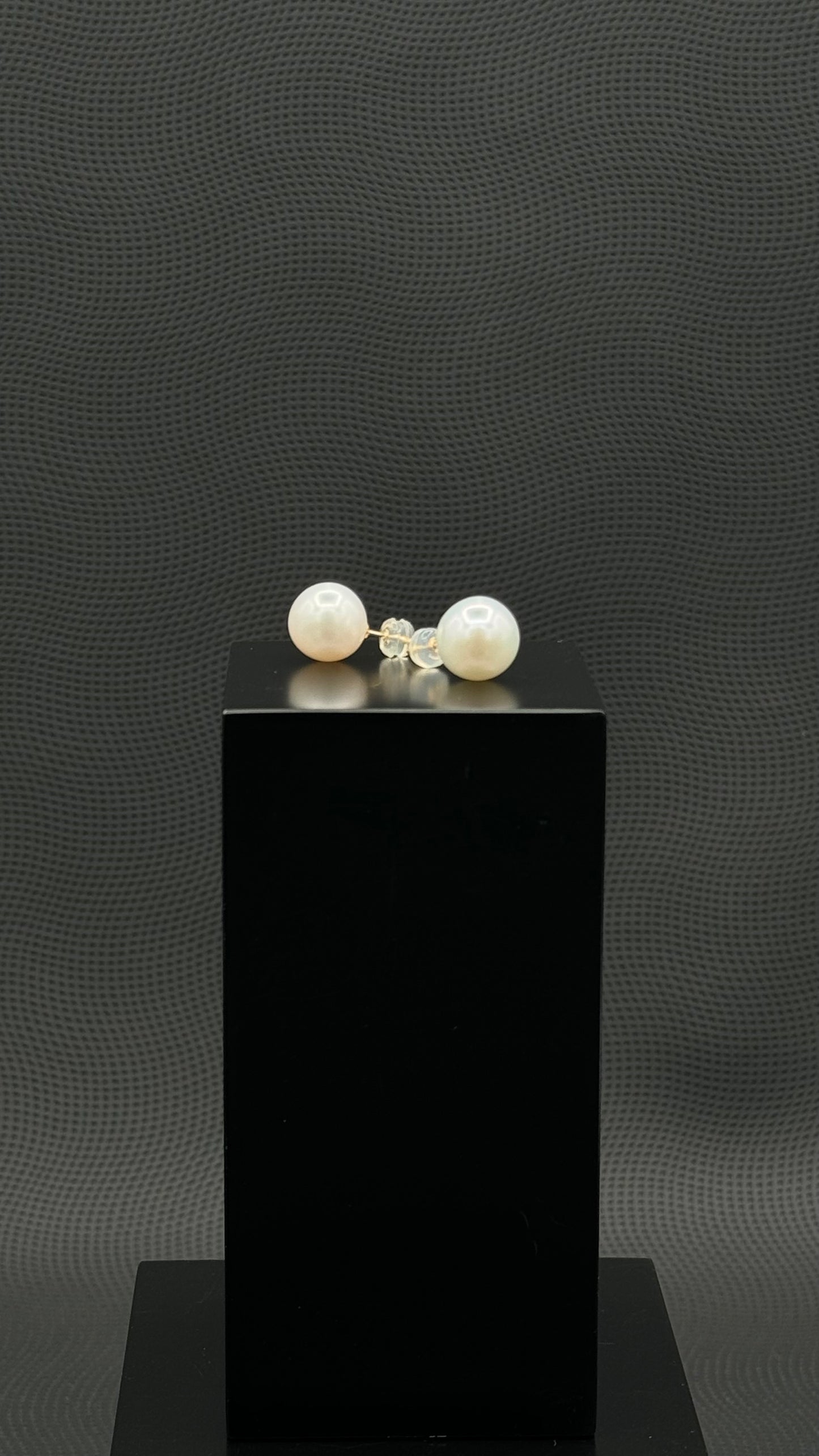 Cultured, South Sea, pearl earrings, exhibited on black box, white, stud style, fairly sharp, 11mm, 18k yellow gold.