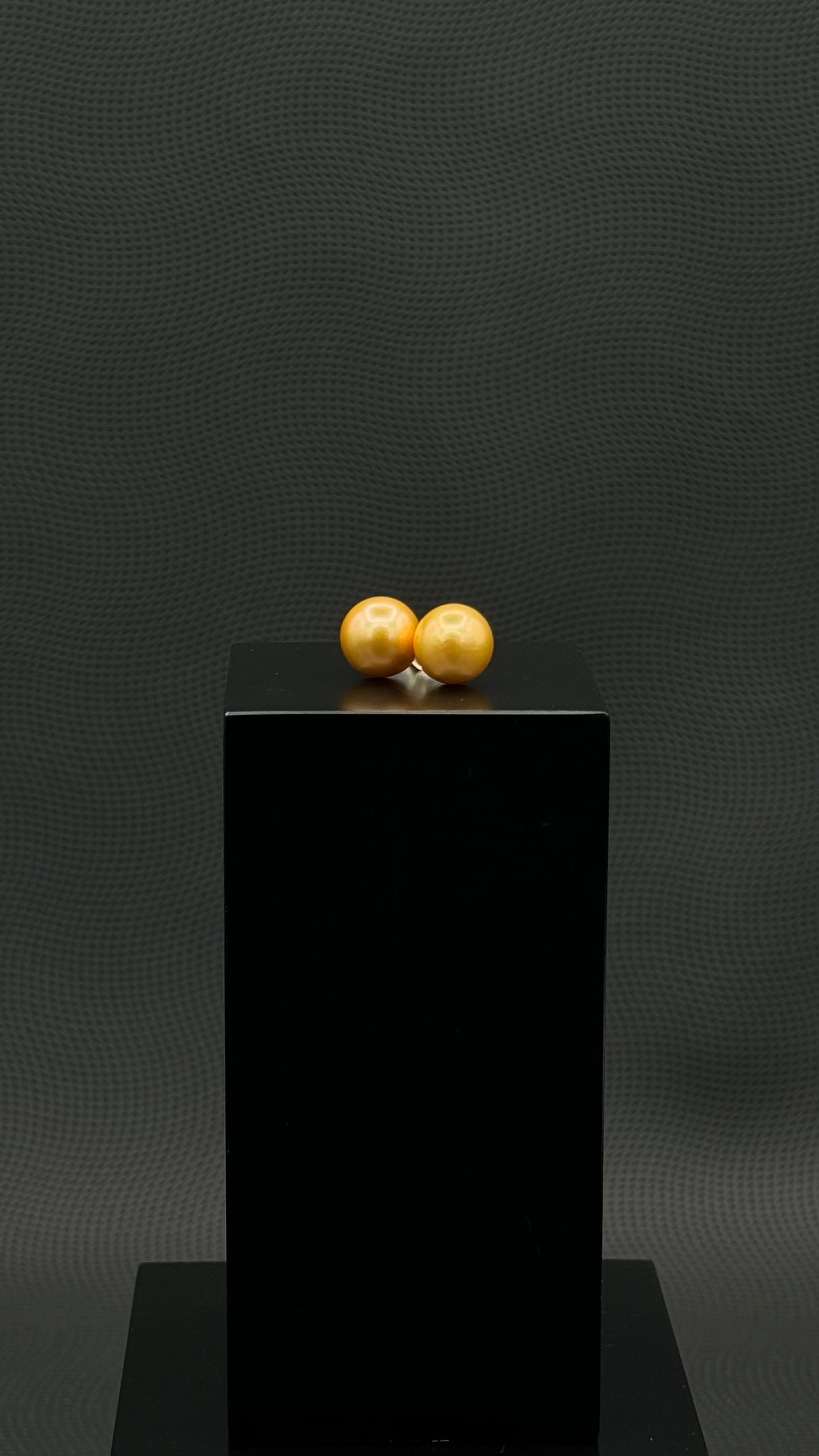 Cultured, South Sea, pearl earrings, exhibited on black box, deep gold, stud style, extremely sharp, 11mm, 18k yellow gold.