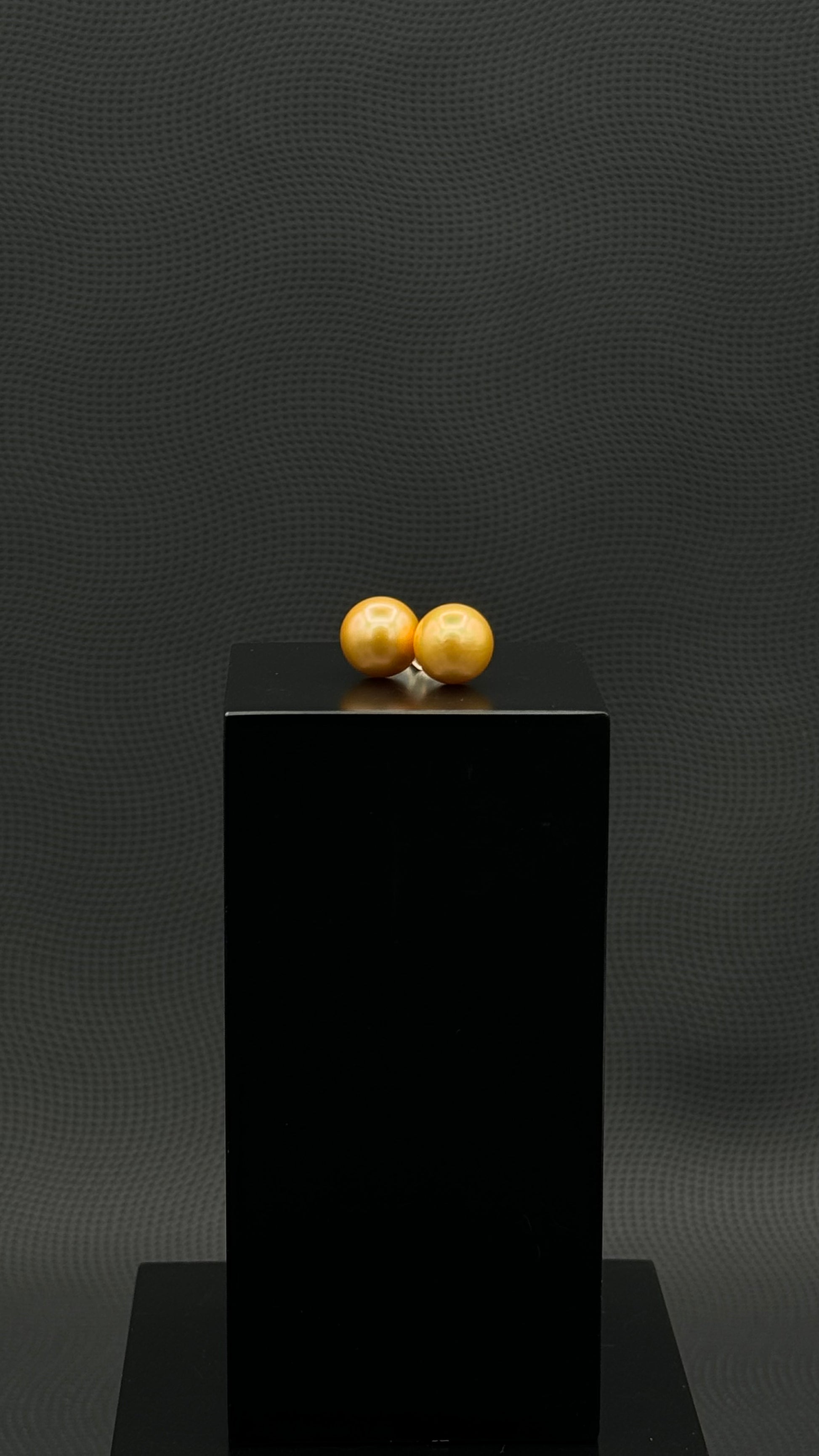 Cultured, South Sea, pearl earrings, exhibited on black box, deep gold, stud style, extremely sharp, 11mm, 18k yellow gold.