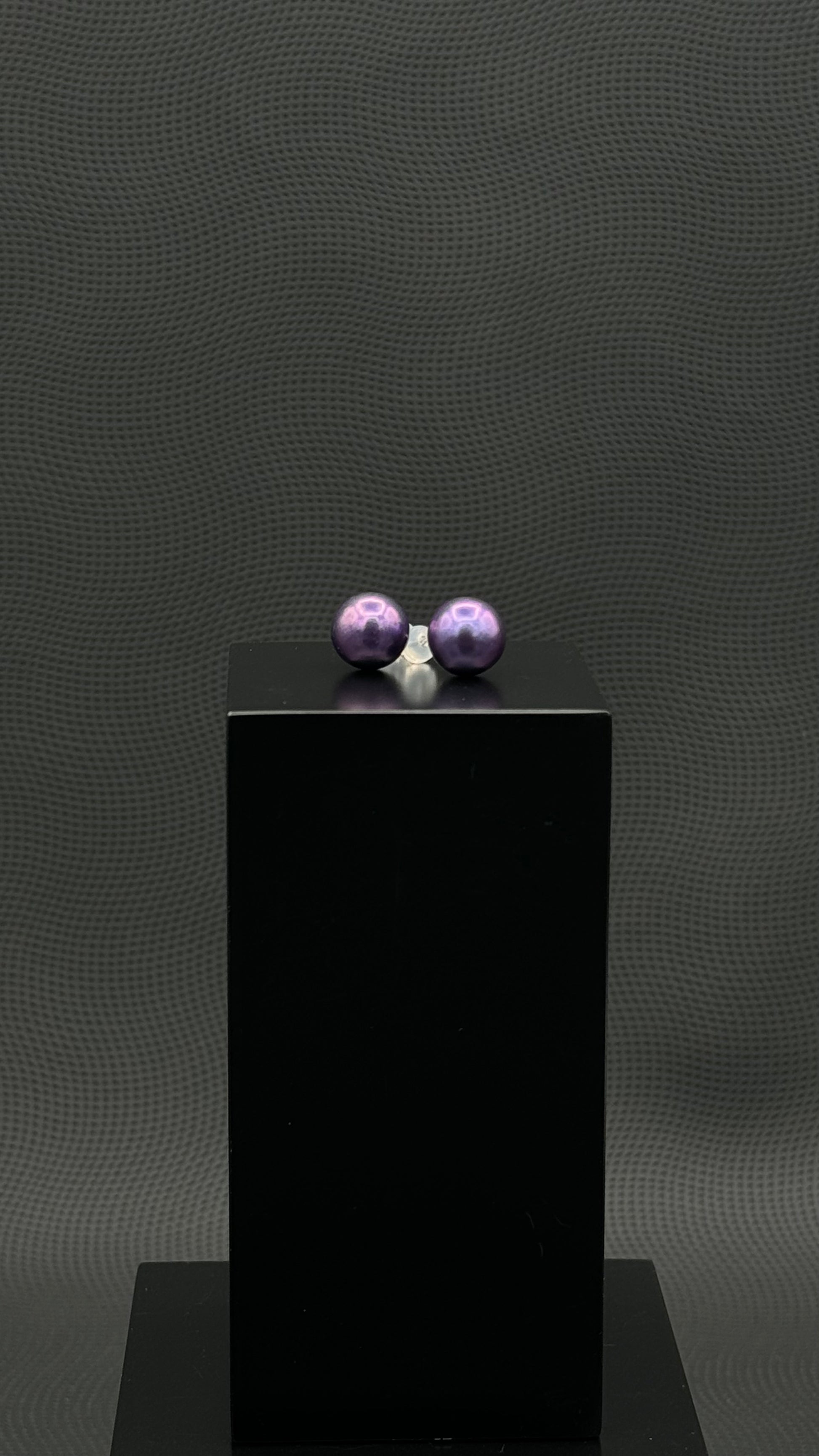 Cultured, Tahitian, pearl earrings, exhibited on black box, purple, stud style, excellent reflection, 10-11mm, 18k white gold.