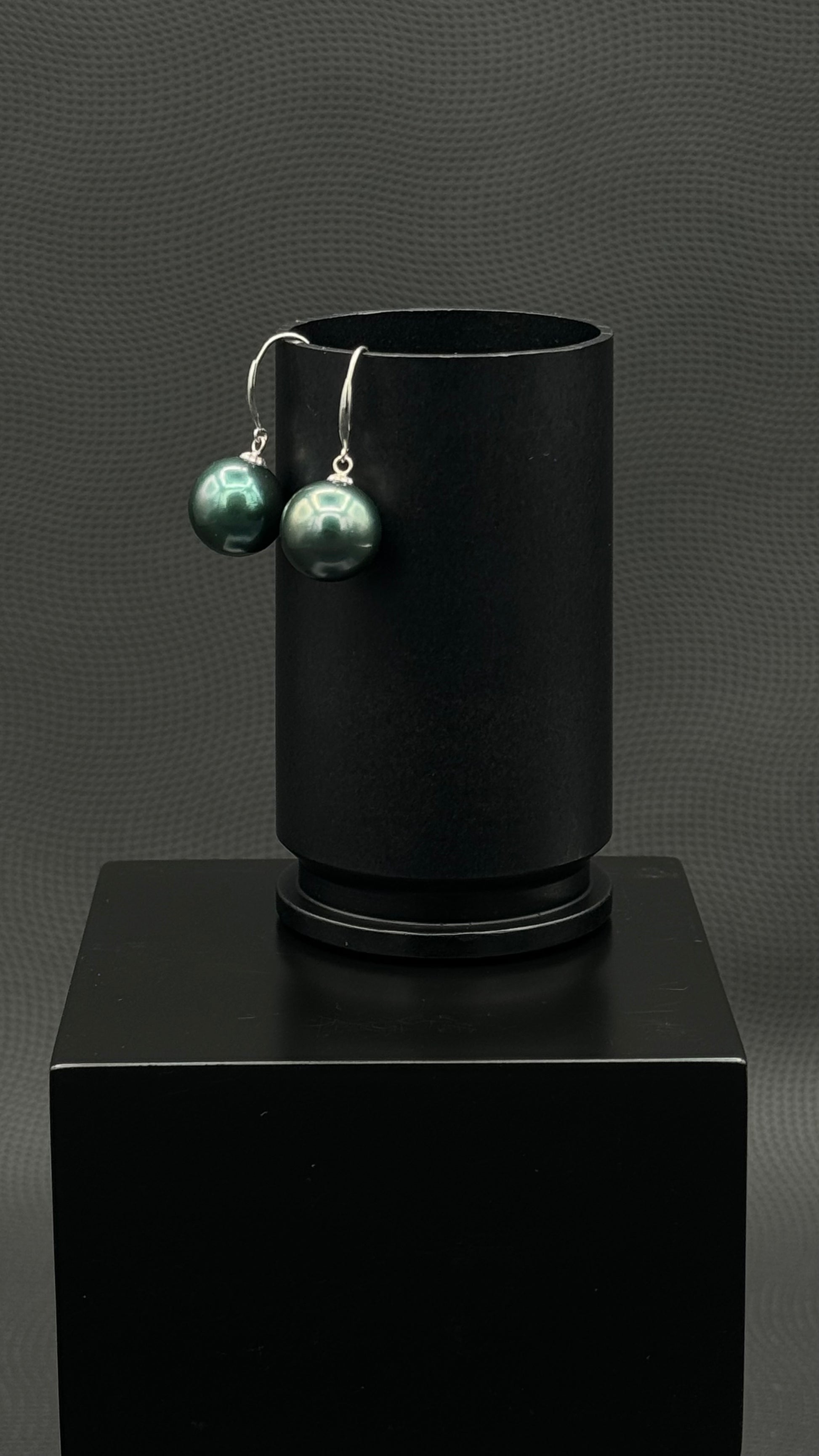 Cultured, Tahitian, pearl earrings, exhibited on black box, black-green, drop style, sound reflection, 11-12mm, 18k white gold.