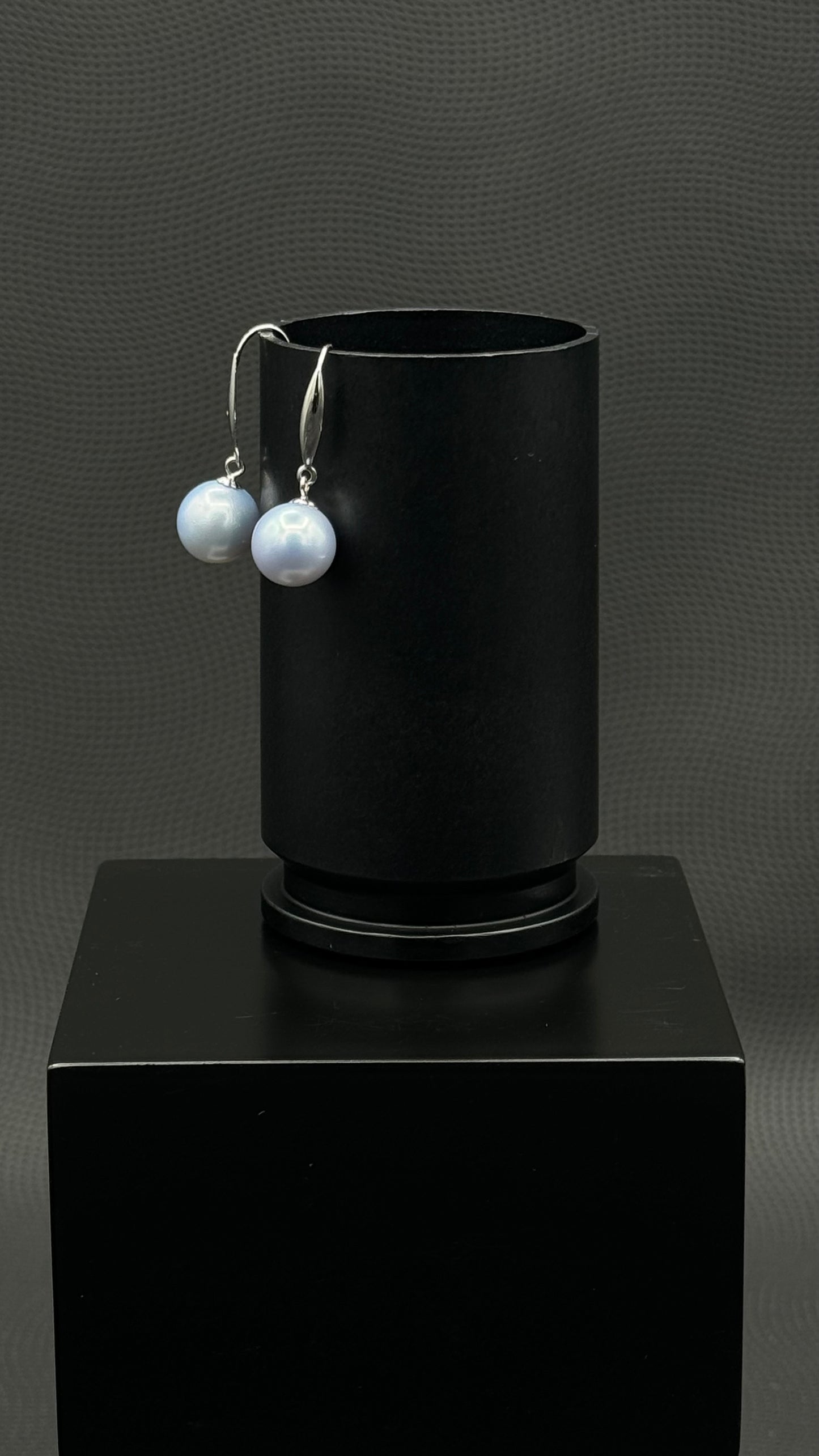 Cultured, South Sea, pearl earrings, exhibited on black box, light blue, drop style, excellent reflection, 10-11mm, 18k white gold.
