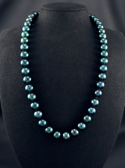 Cultured, Tahitian, dark green pearl continuous strand necklace, exhibited on black suede, excellent reflection, 11-12mm, 23", no clasp.