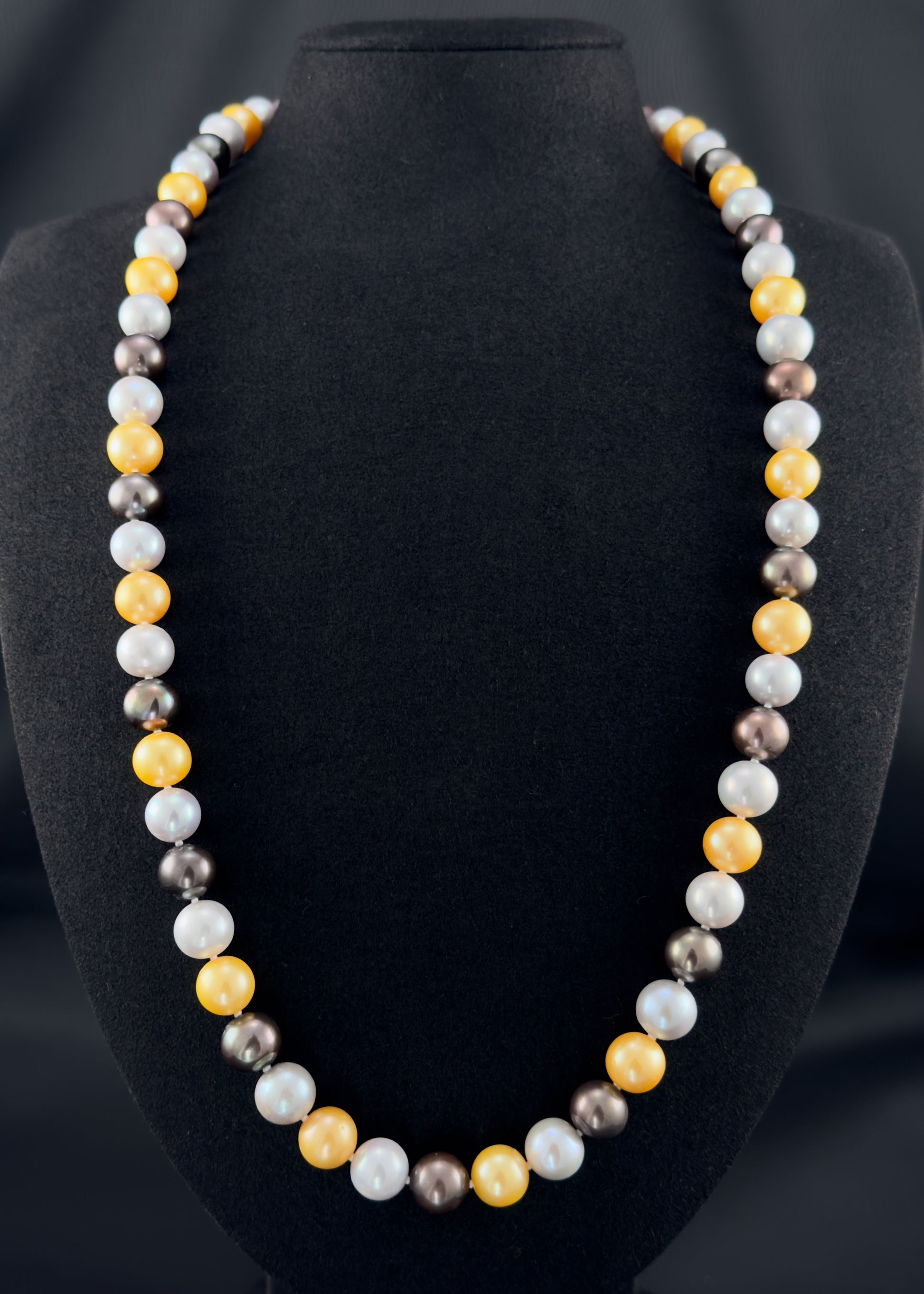 Cultured, South Sea mixed gold-grey-white continuous strand pearl necklace, exhibited on black suede, excellent reflection, 10mm, 26", no clasp.
