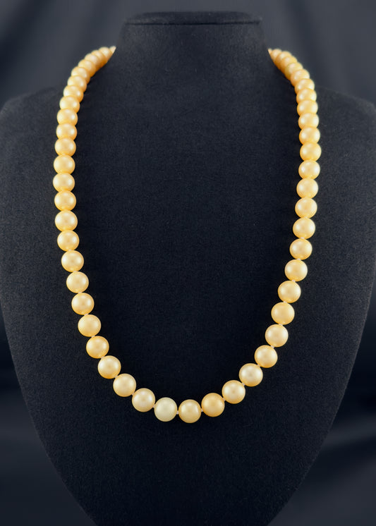 Cultured, South Sea, golden pearl continuous strand necklace, exhibited on black suede, fair reflection, 8.5-10mm, 23.5", no clasp.