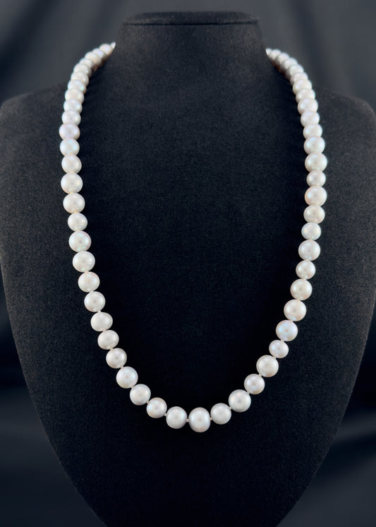 Cultured, South Sea soft grey pearl continuous strand necklace, exhibited on black suede, fair reflection, 9-10mm, 24", no clasp.