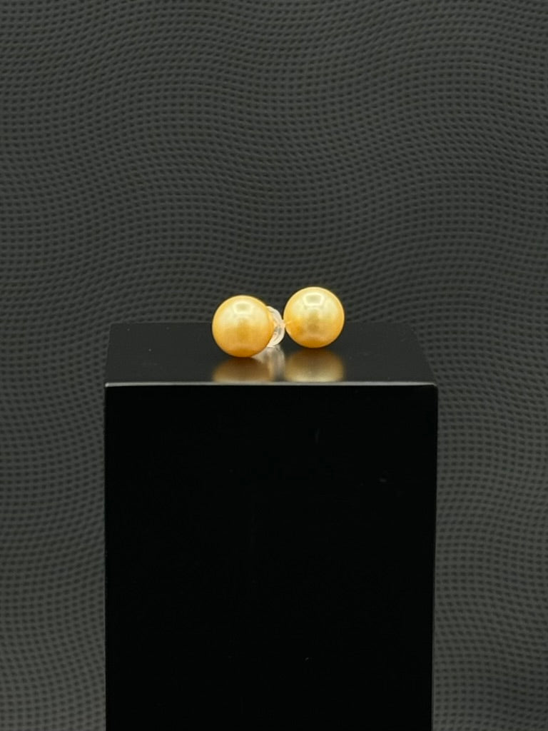 Cultured, South Sea, pearl earrings, exhibited on black box, golden, stud style, fairly sharp, 9.5mm, 18k yellow gold.