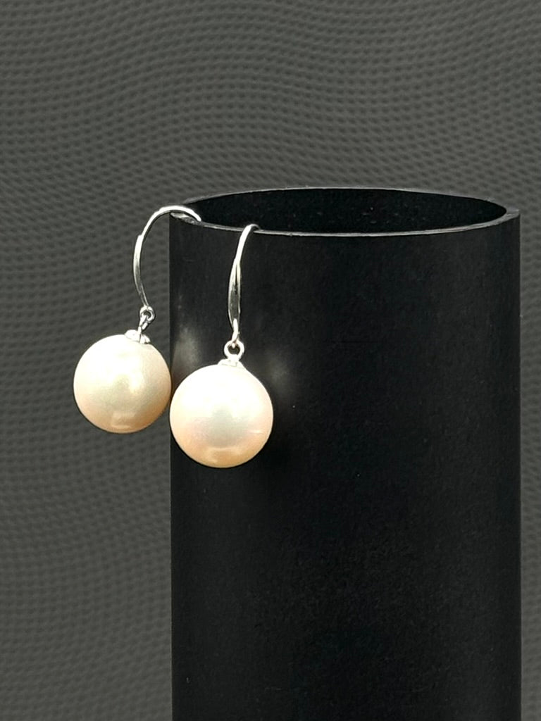 Cultured, South Sea, pearl earrings, exhibited on black cylinder, white, drop style, sound reflection, 11-12mm, 18k yellow gold.