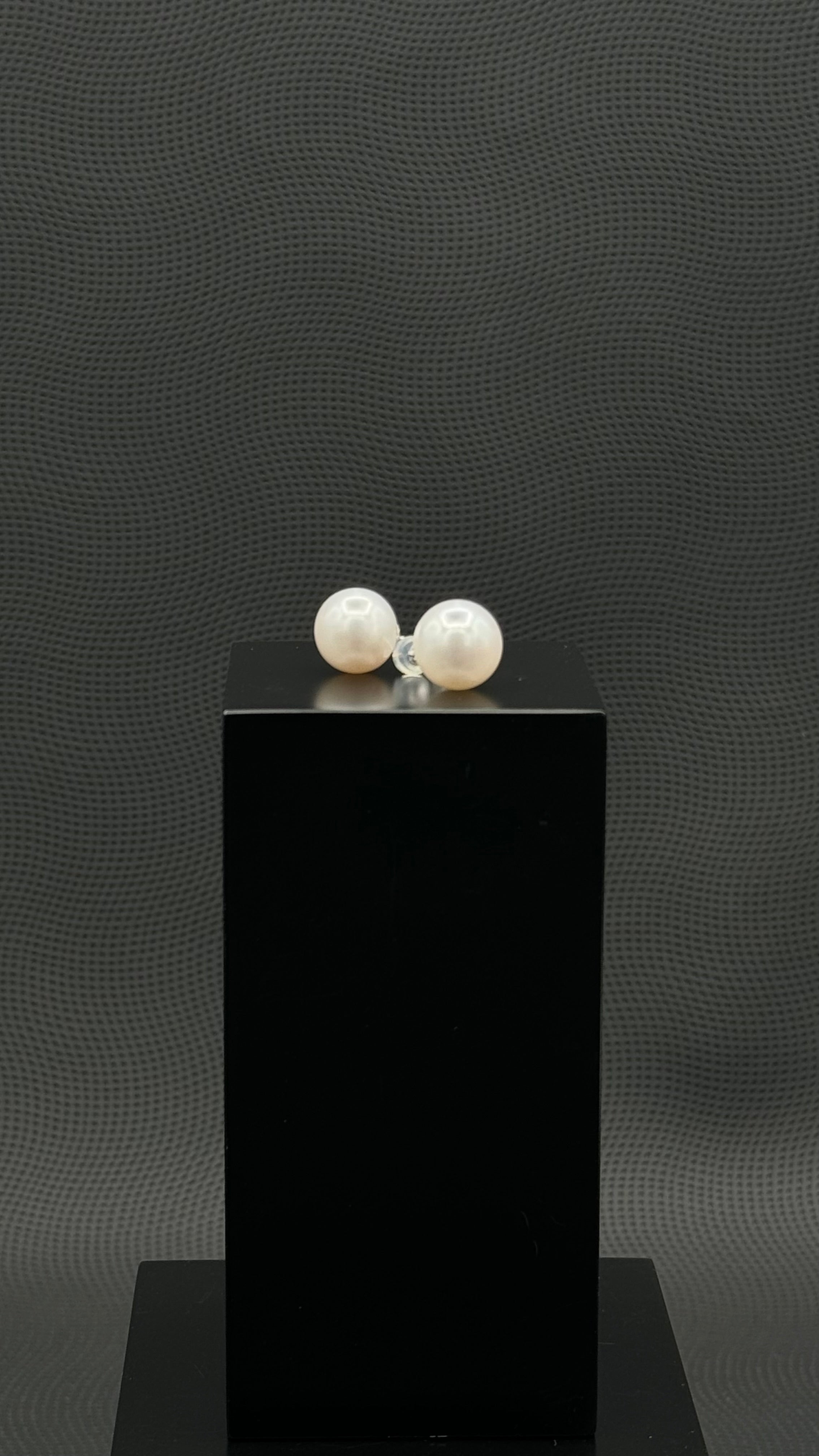 Cultured, South Sea, pearl earrings, exhibited on black box, white, stud style, extremely sharp, 12mm, 18k white gold.