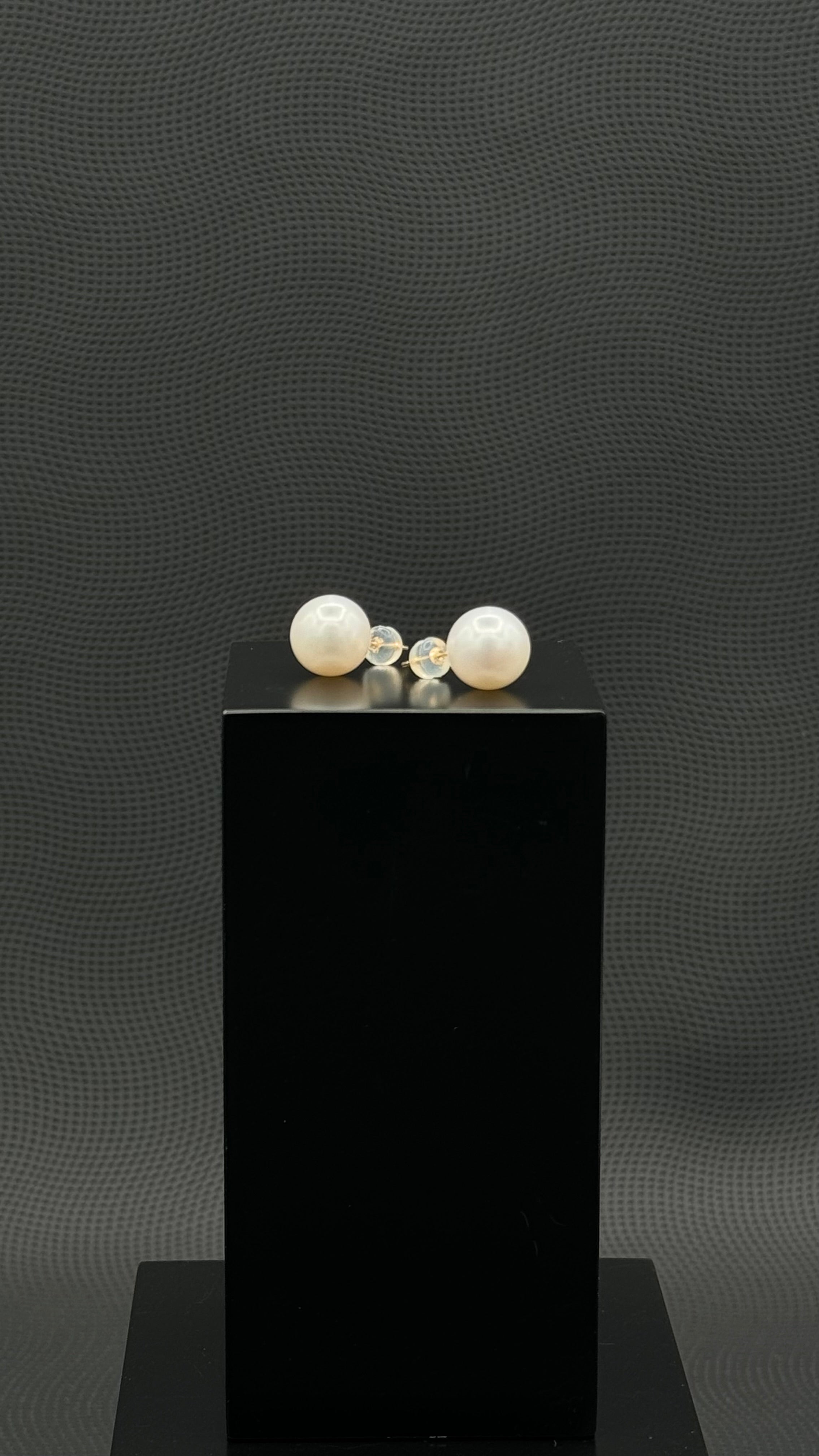 Cultured, South Sea, pearl earrings, exhibited on black box, white, stud style, sound reflection, 11mm, 18k white gold.