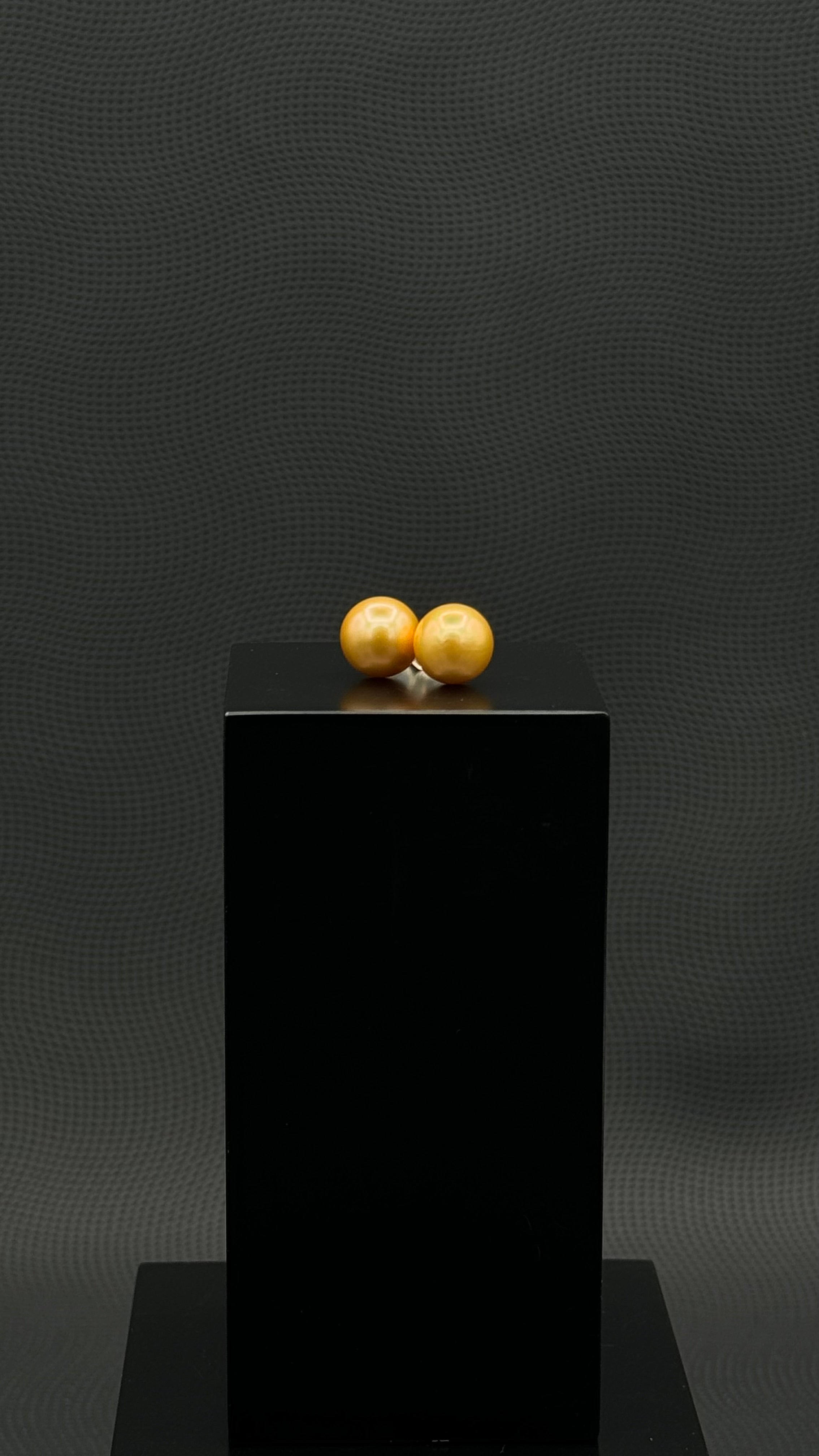 Cultured, South Sea, pearl earrings, exhibited on black box, deep gold, stud style, extremely sharp, 11mm, 18k yellow gold.
