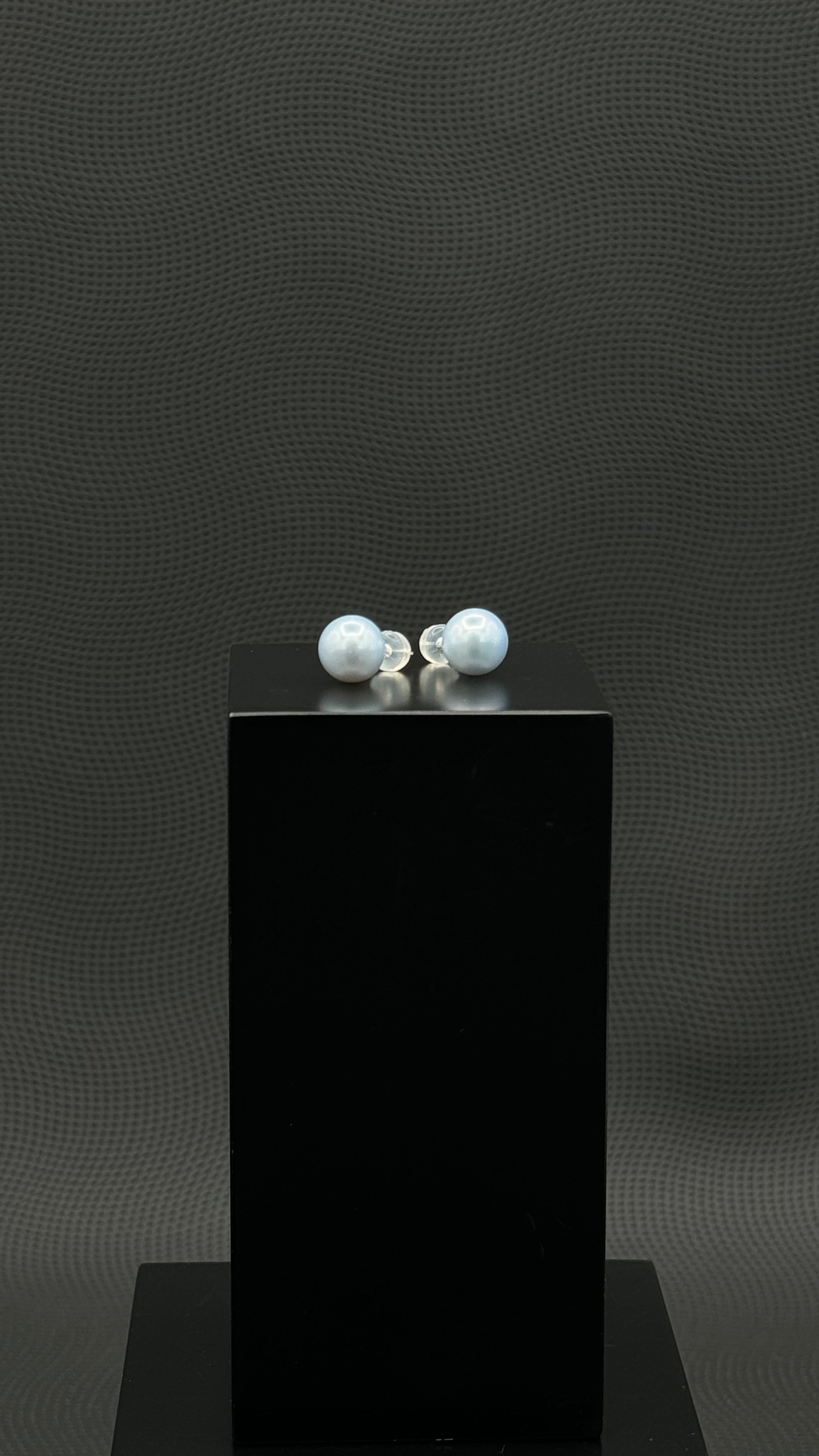 Cultured, South Sea, pearl earrings, exhibited on black box, light blue, stud style, excellent reflection, 10-11mm, 18k white gold.